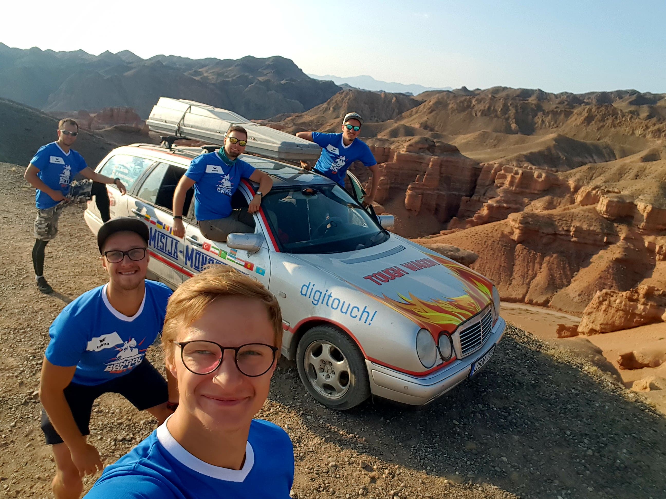 Convoy vehicles on a long-distance rally stage across open terrain
