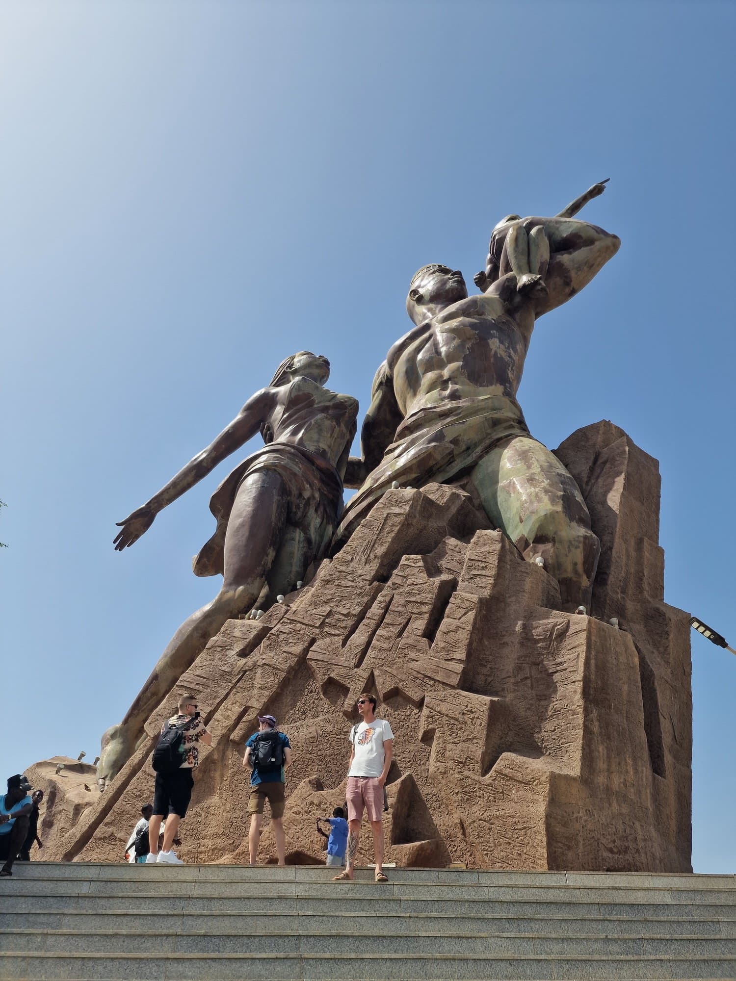 The bronze African Renaissance Monument above Dakar with visitors on the steps