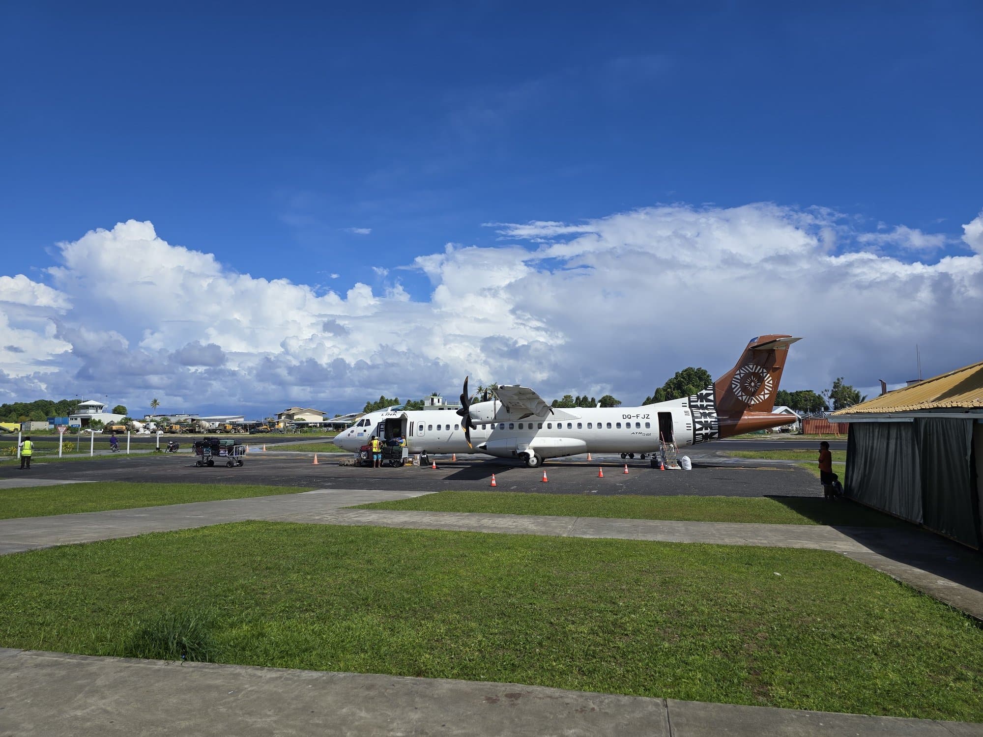 The ATR parked at Funafuti's airstrip under big clouds