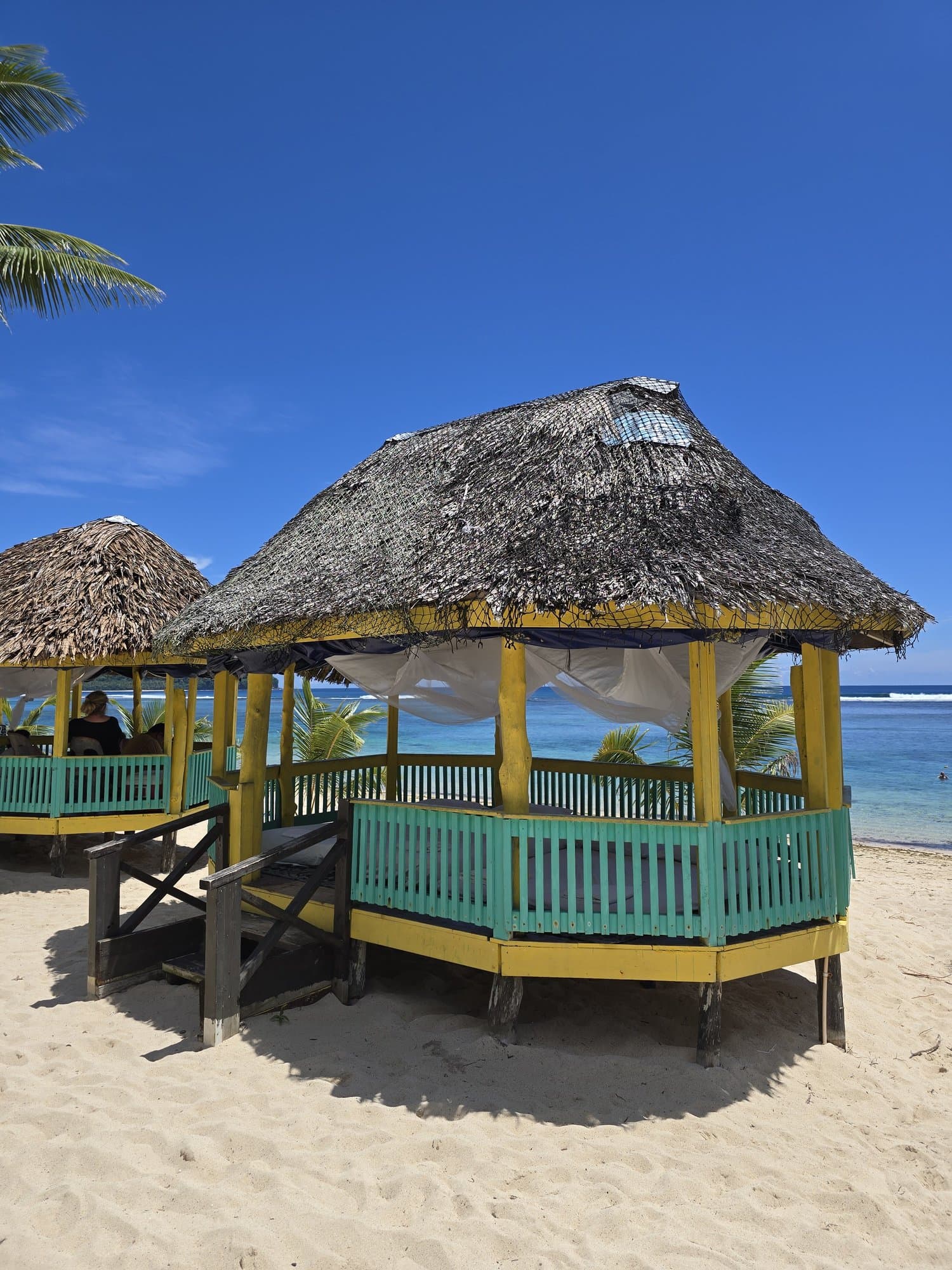 A thatched beach fale on white sand