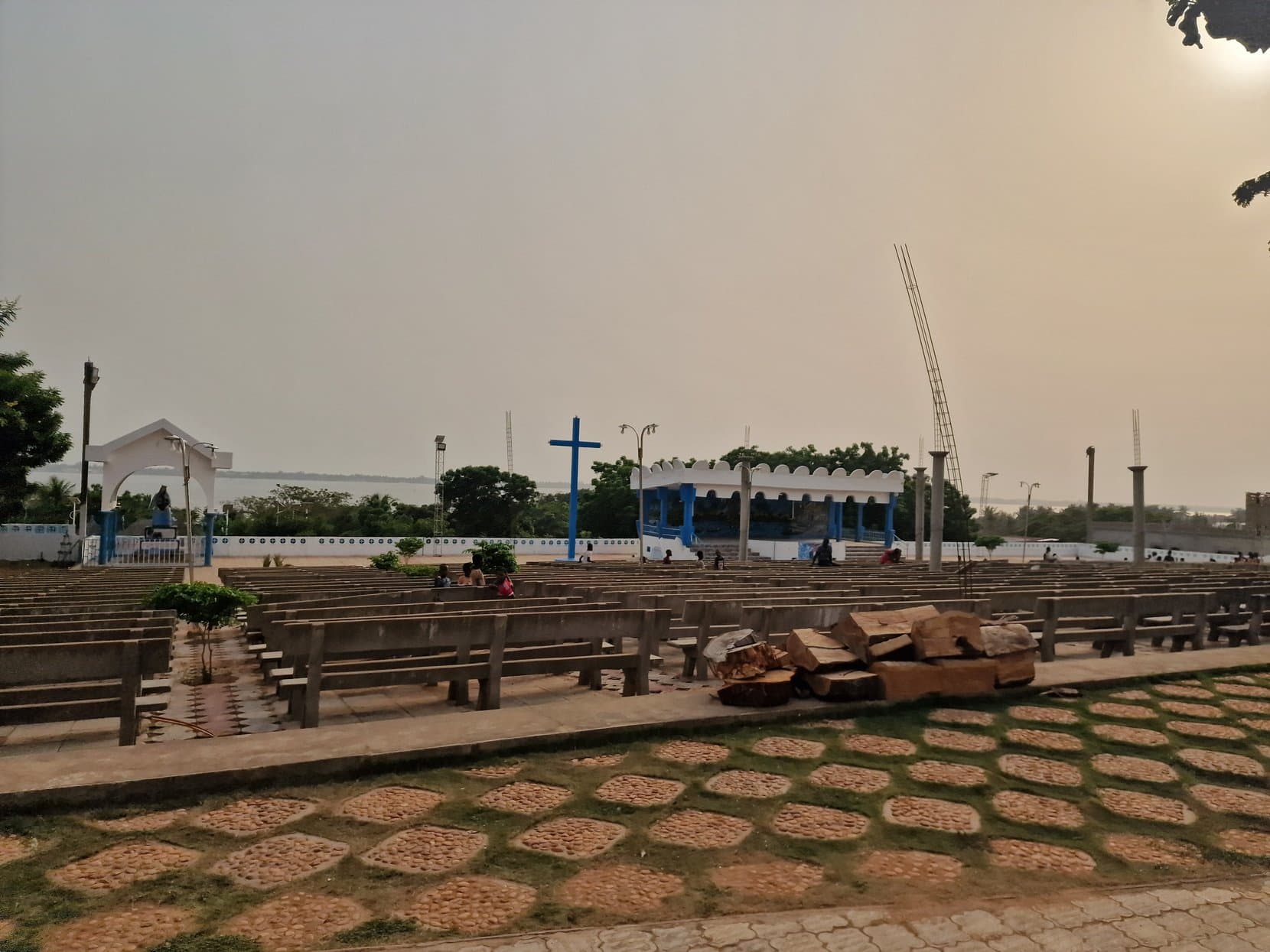 Rows of open-air benches facing a cross and a stage at the papal site, Togoville, Togo