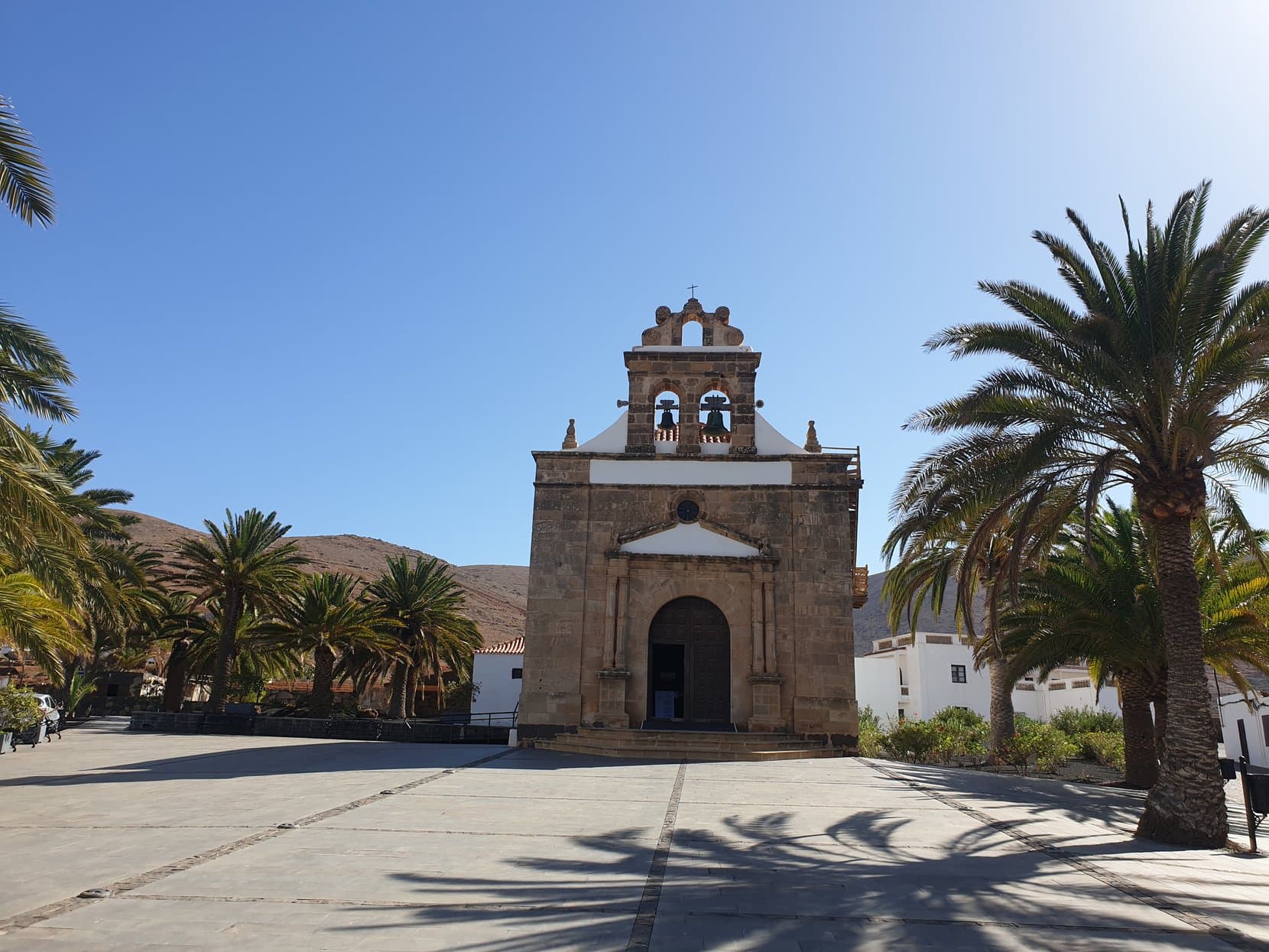 The white church of Betancuria with palms over its plaza, Fuerteventura