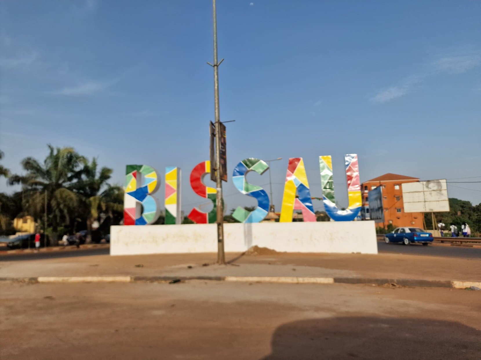 Multicoloured letters spelling BISSAU at a roundabout in the capital