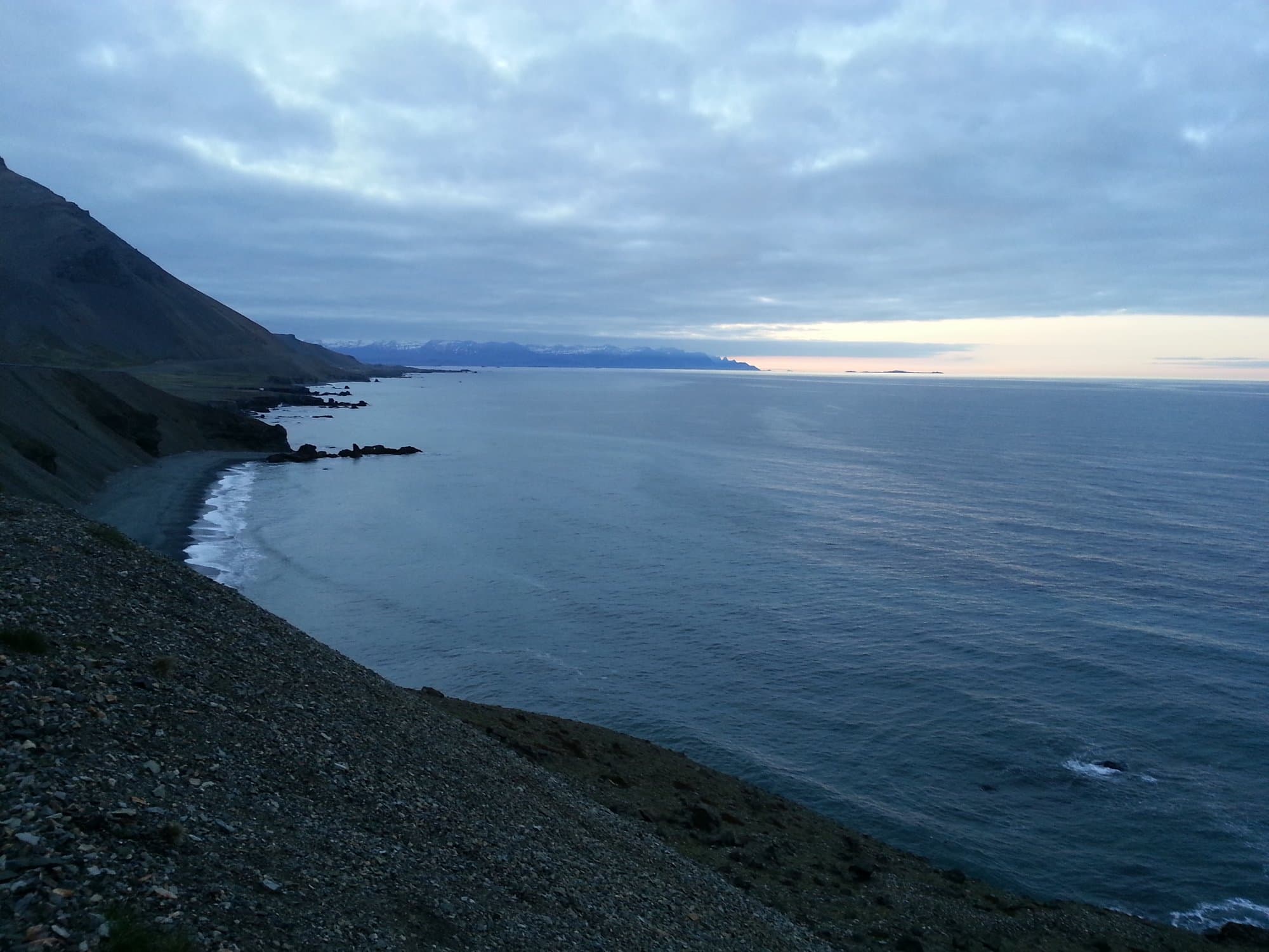 Black sand coast under the pale light of an Icelandic summer night