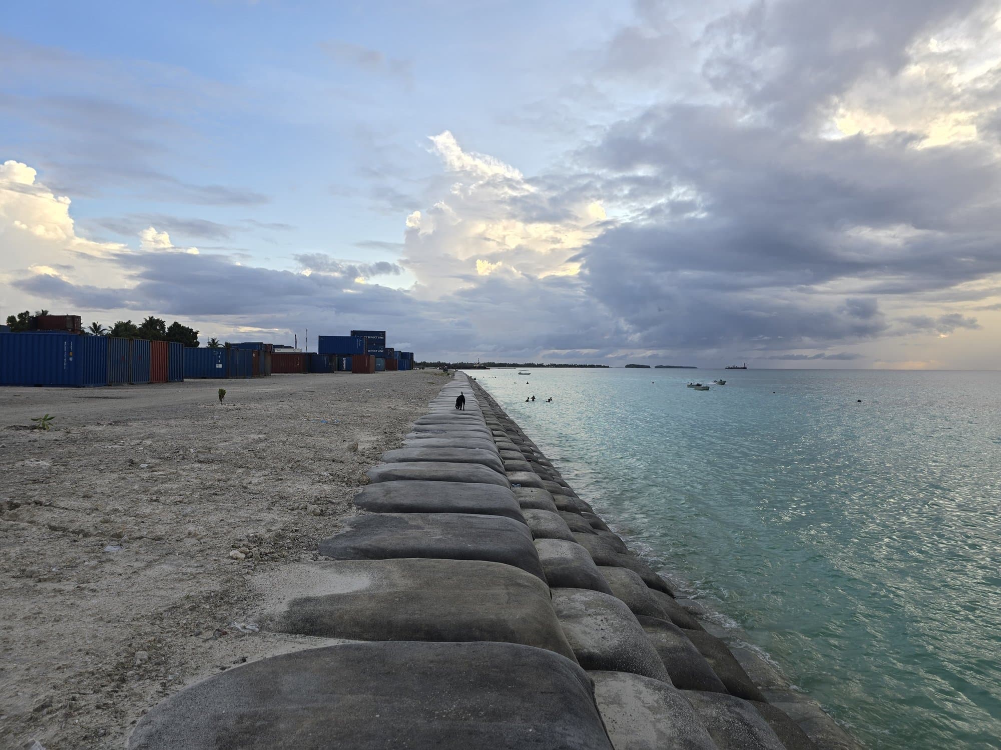 The geotube causeway with shipping containers stacked beside it