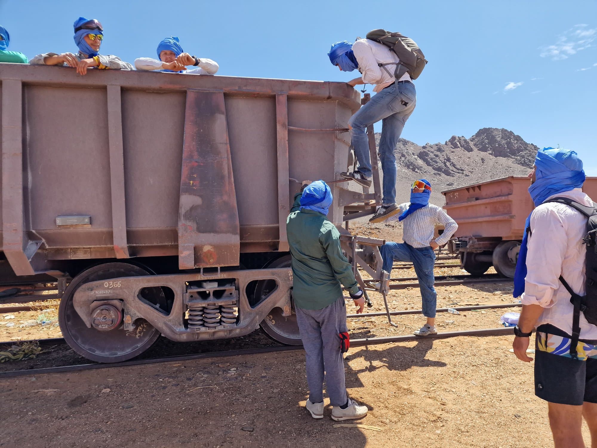 A traveller climbing the ladder of an iron-ore wagon