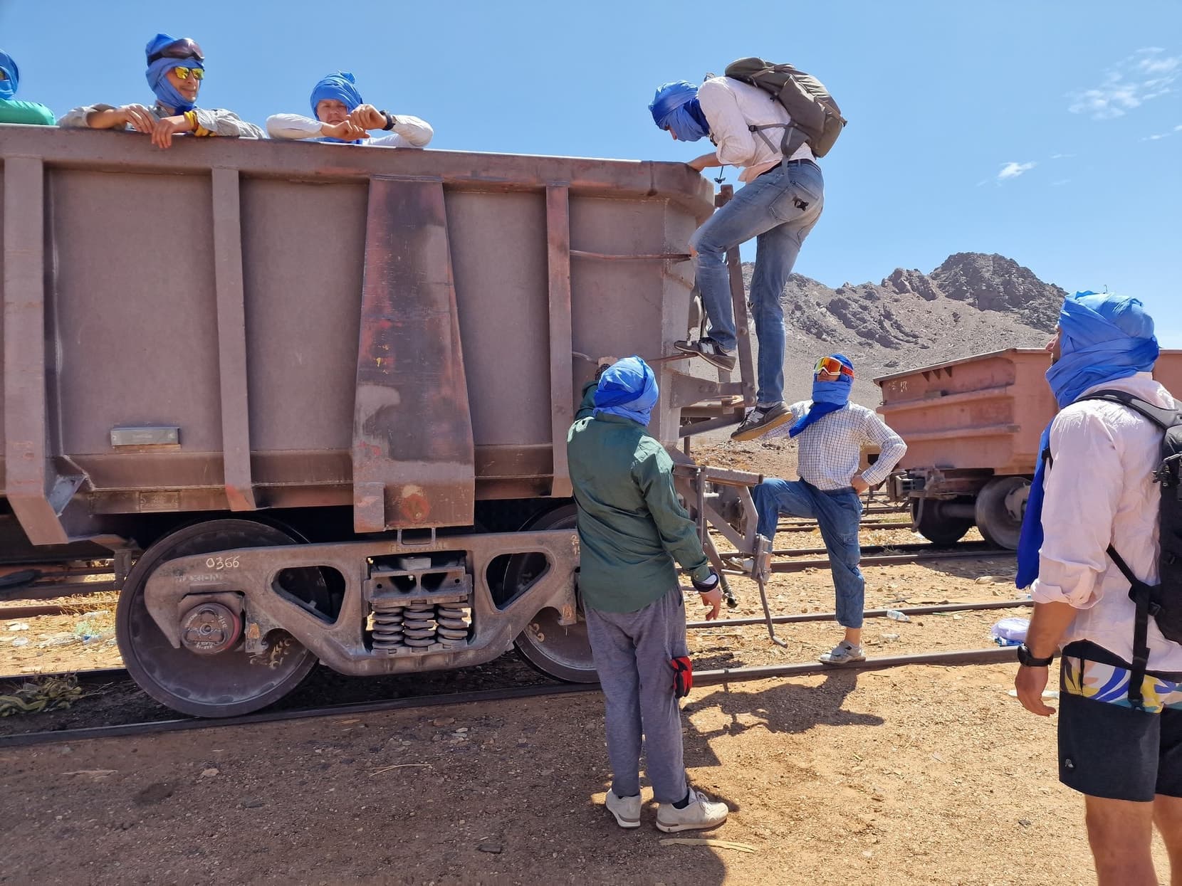 A traveller climbing the ladder of an iron-ore wagon