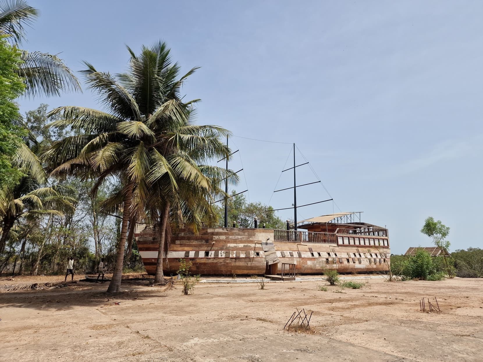 A ship-shaped concrete structure under palms by the creeks near Lamin