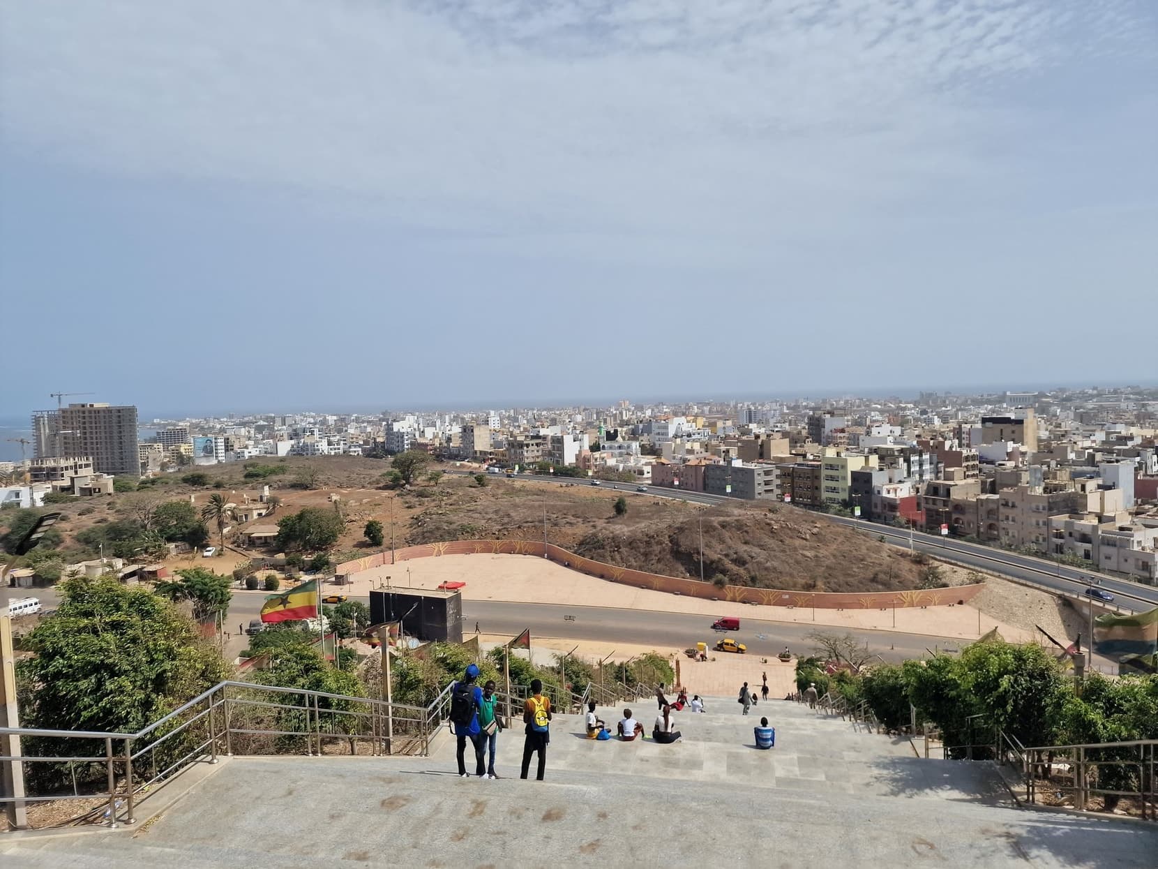 Dakar's low rooftops spreading below the hill of the African Renaissance Monument