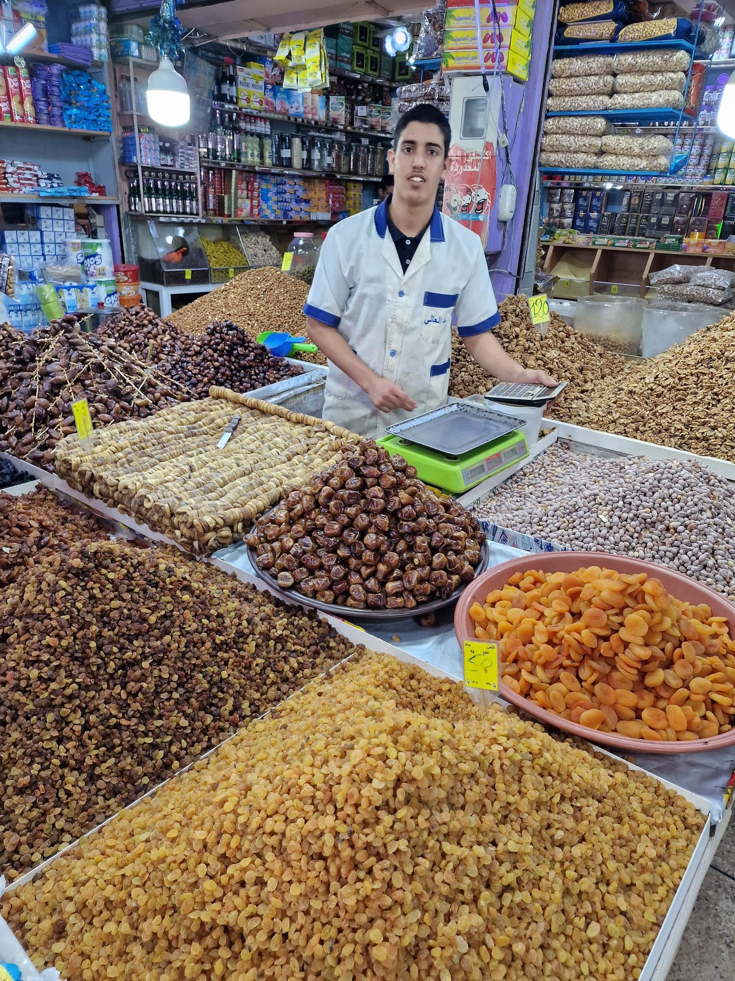 A vendor at a dates and dried-fruit stall in Dakhla's market