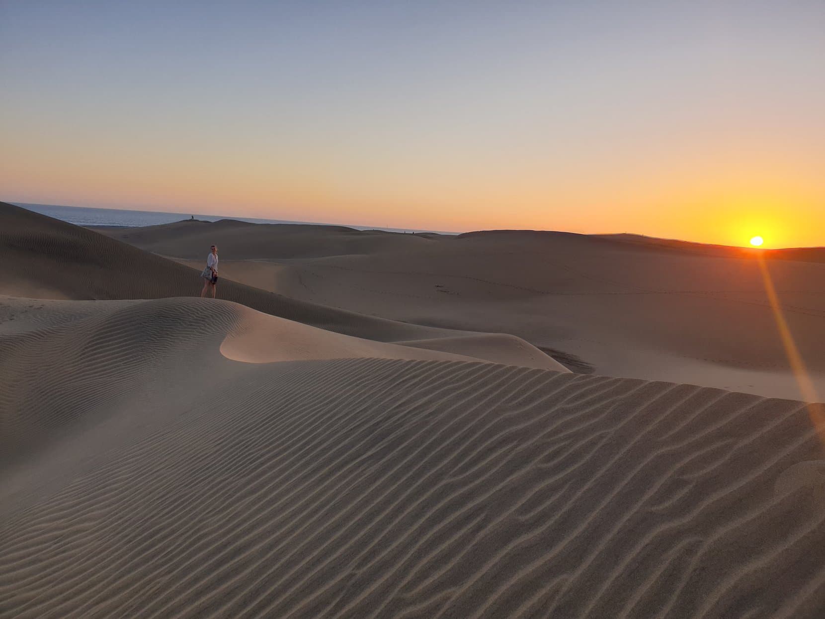 A walker on a Maspalomas dune ridge at sunset, Gran Canaria