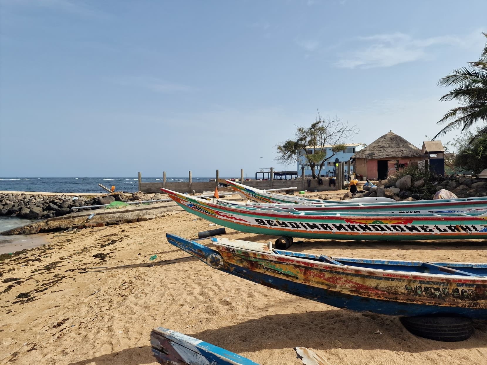 Painted fishing pirogues drawn up on a beach in Dakar