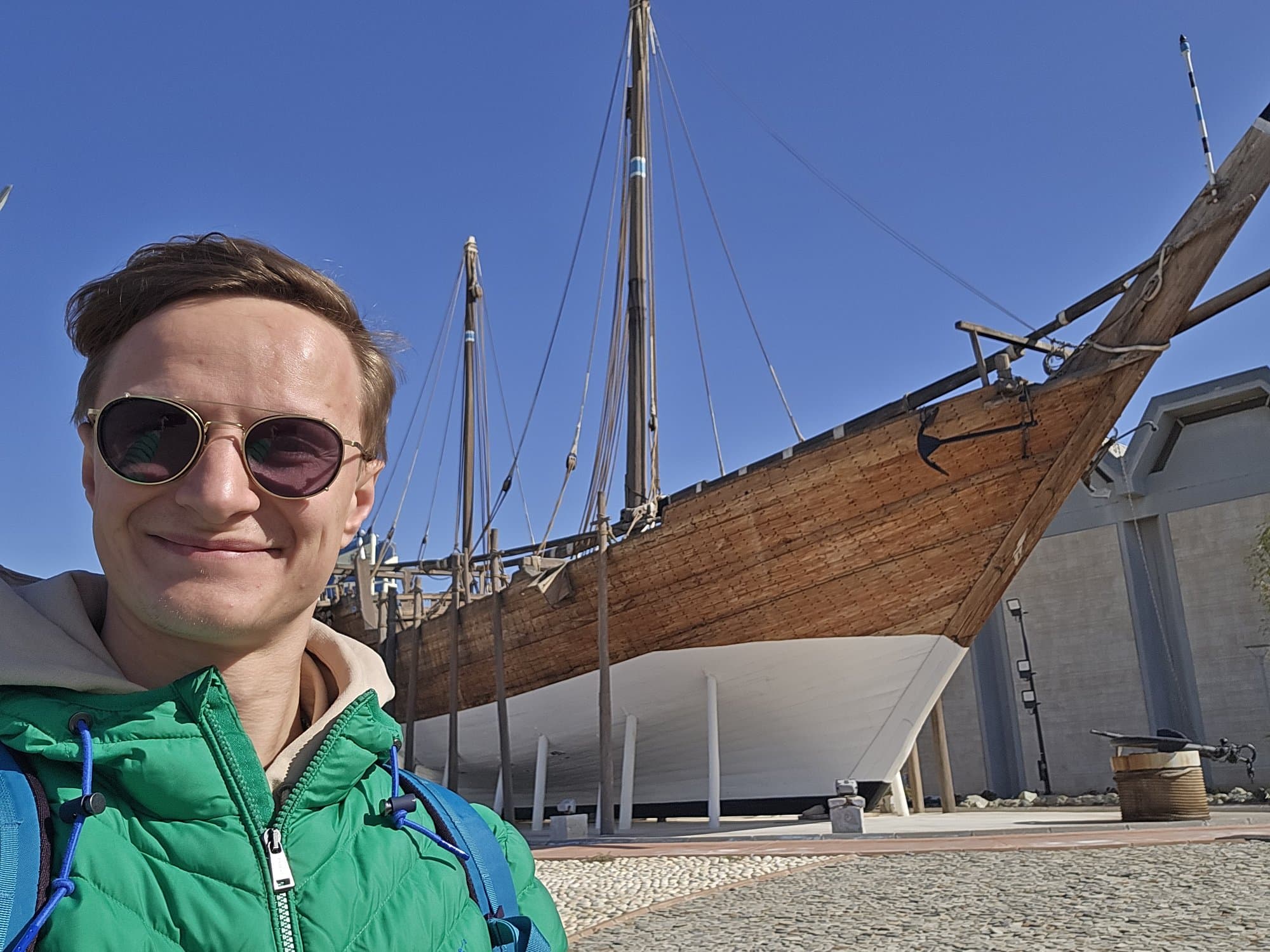 The founder in front of the wooden dhow at the maritime museum