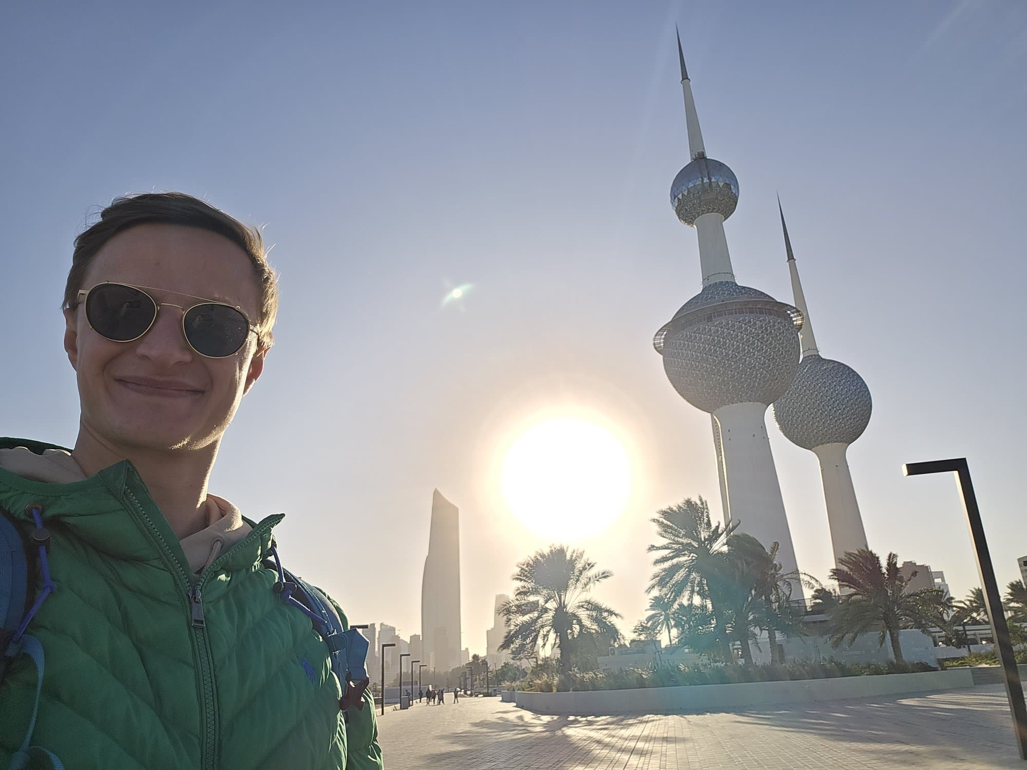 The founder below Kuwait Towers with the sun behind the spheres