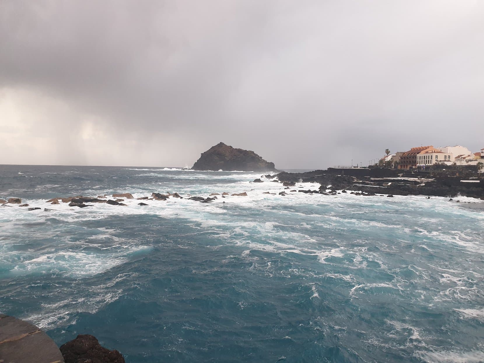 Garachico's offshore roque and natural lava pools under heavy surf, Tenerife