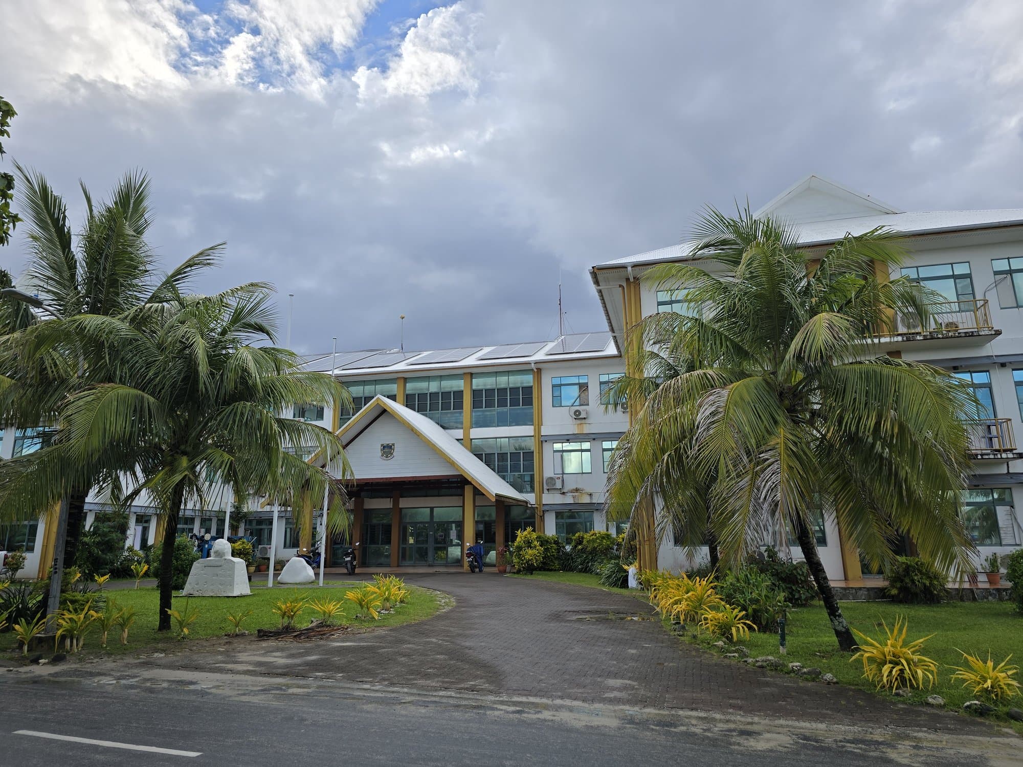 The three-storey government building of Tuvalu behind palms in Vaiaku