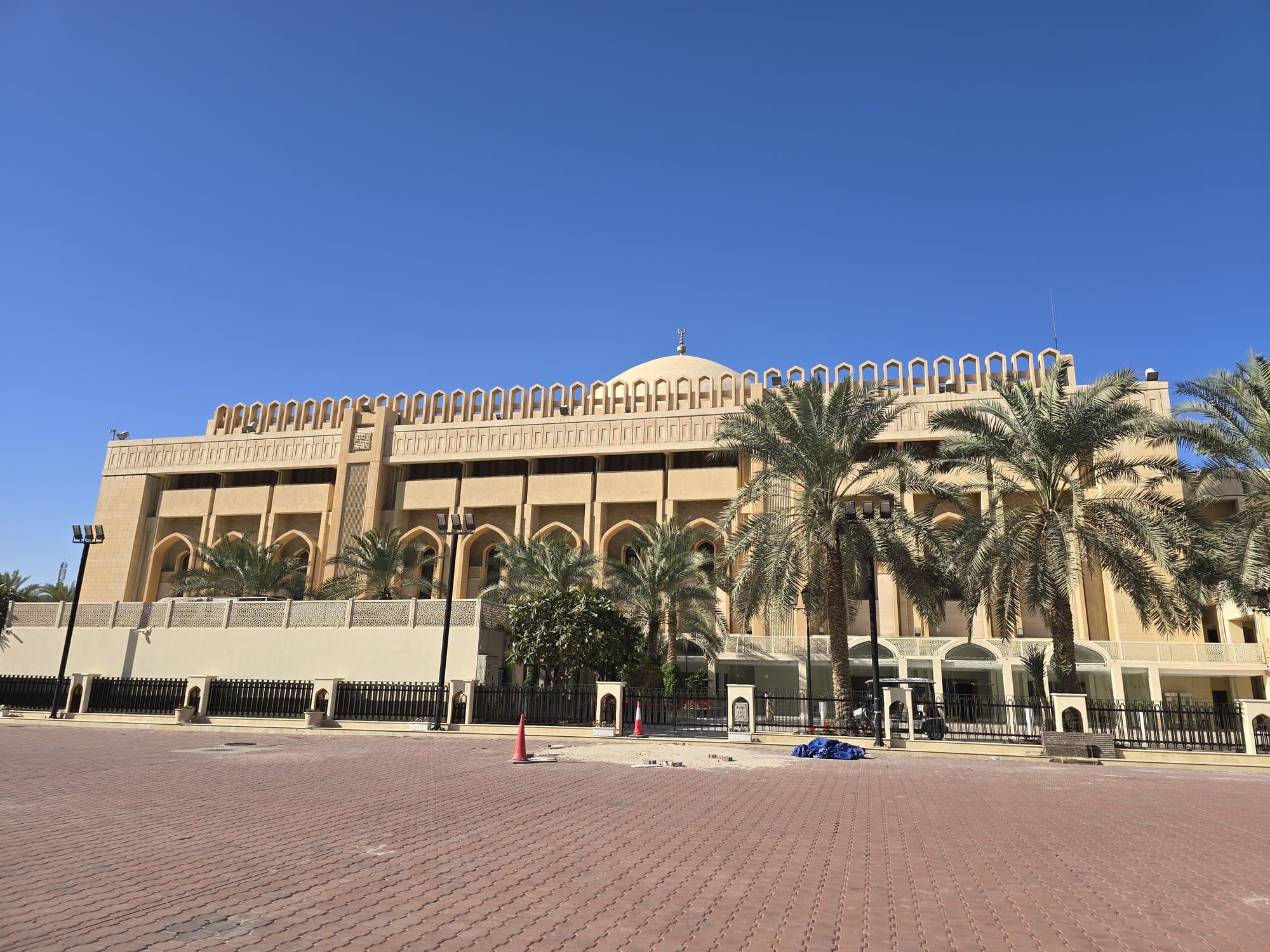 The Grand Mosque of Kuwait from the street, palms along its wall