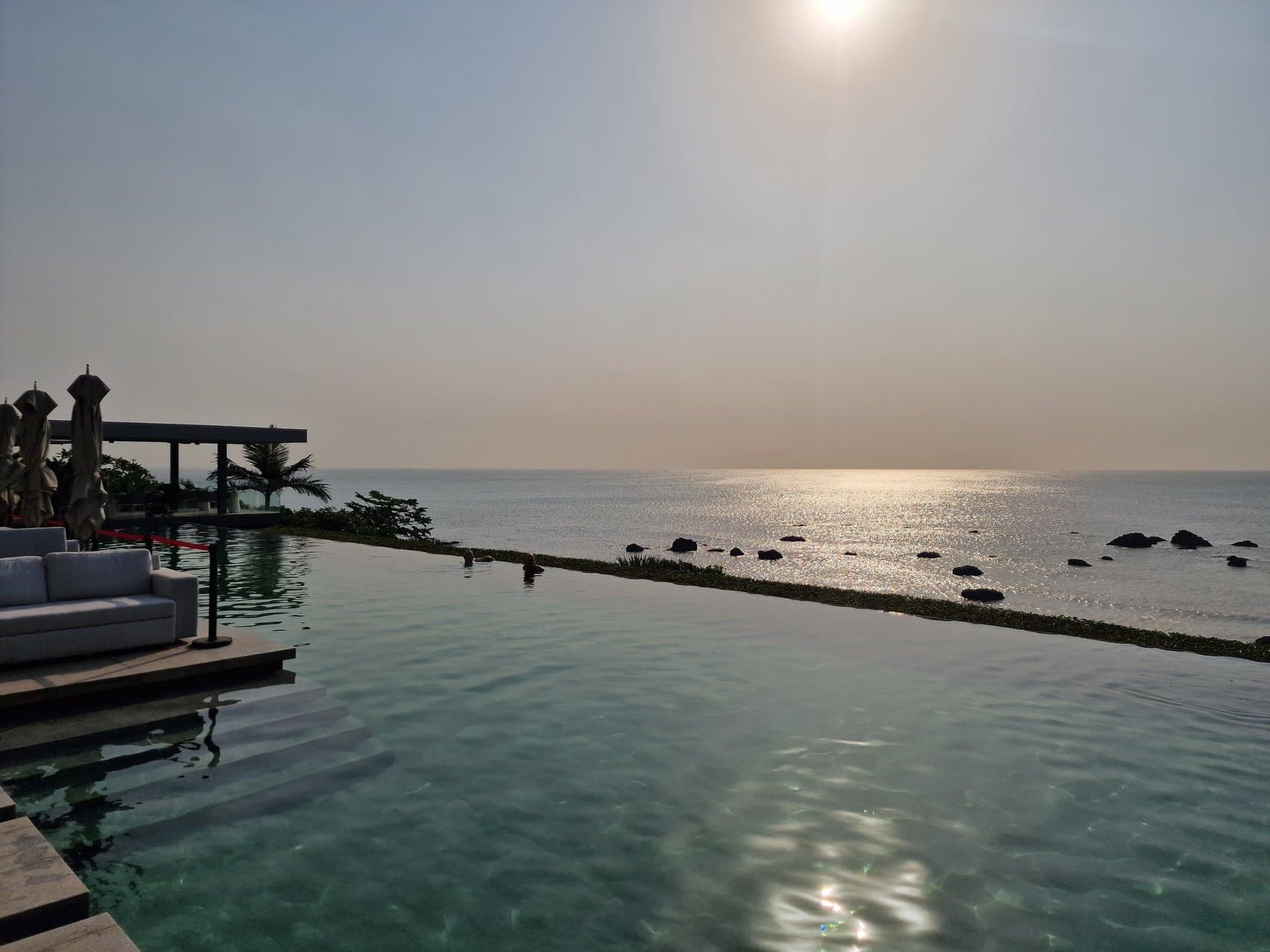 An infinity pool above the Atlantic at dusk in Conakry, Guinea