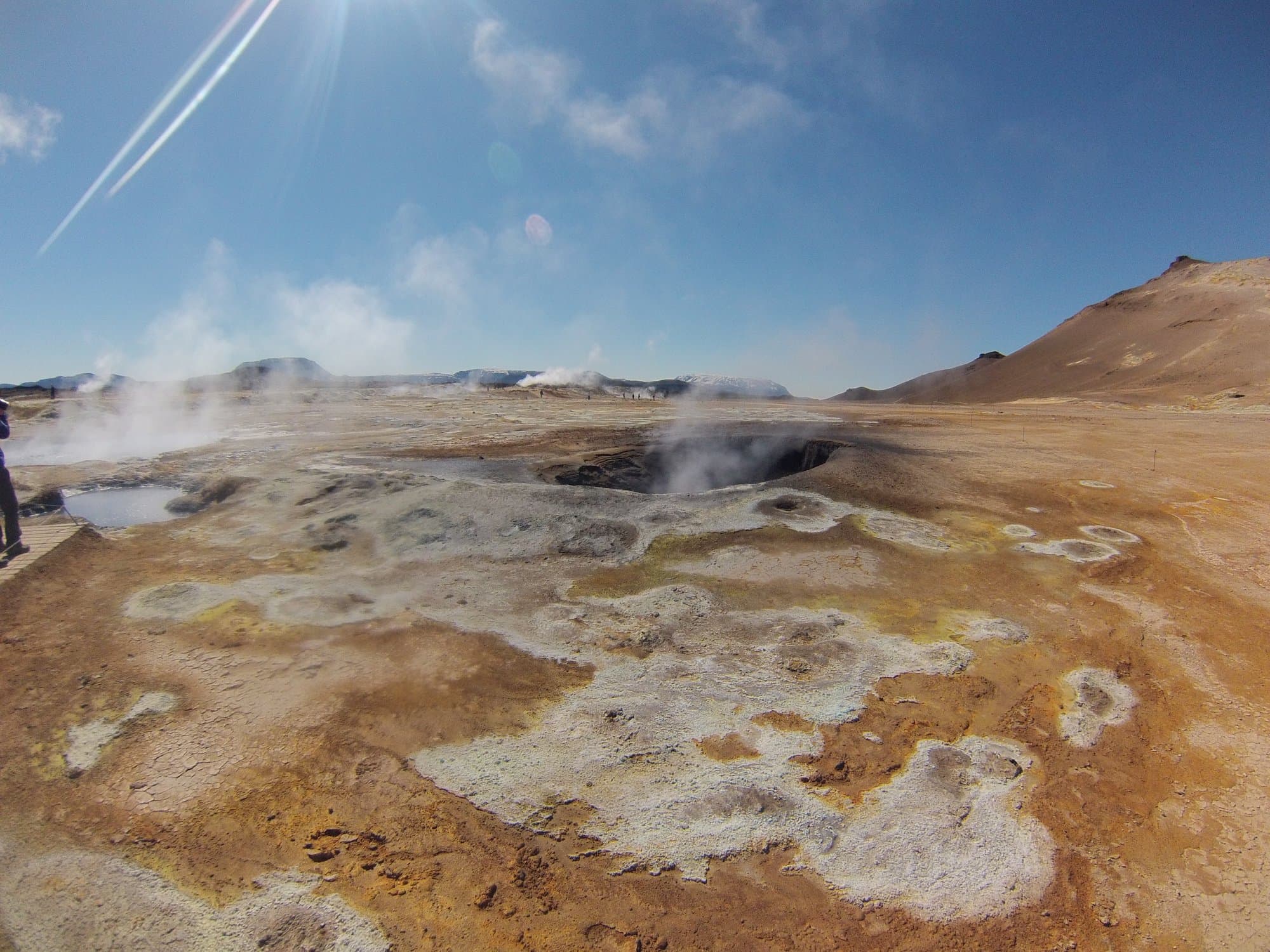Orange mineral ground and steam vents at the Hverir geothermal field, north Iceland