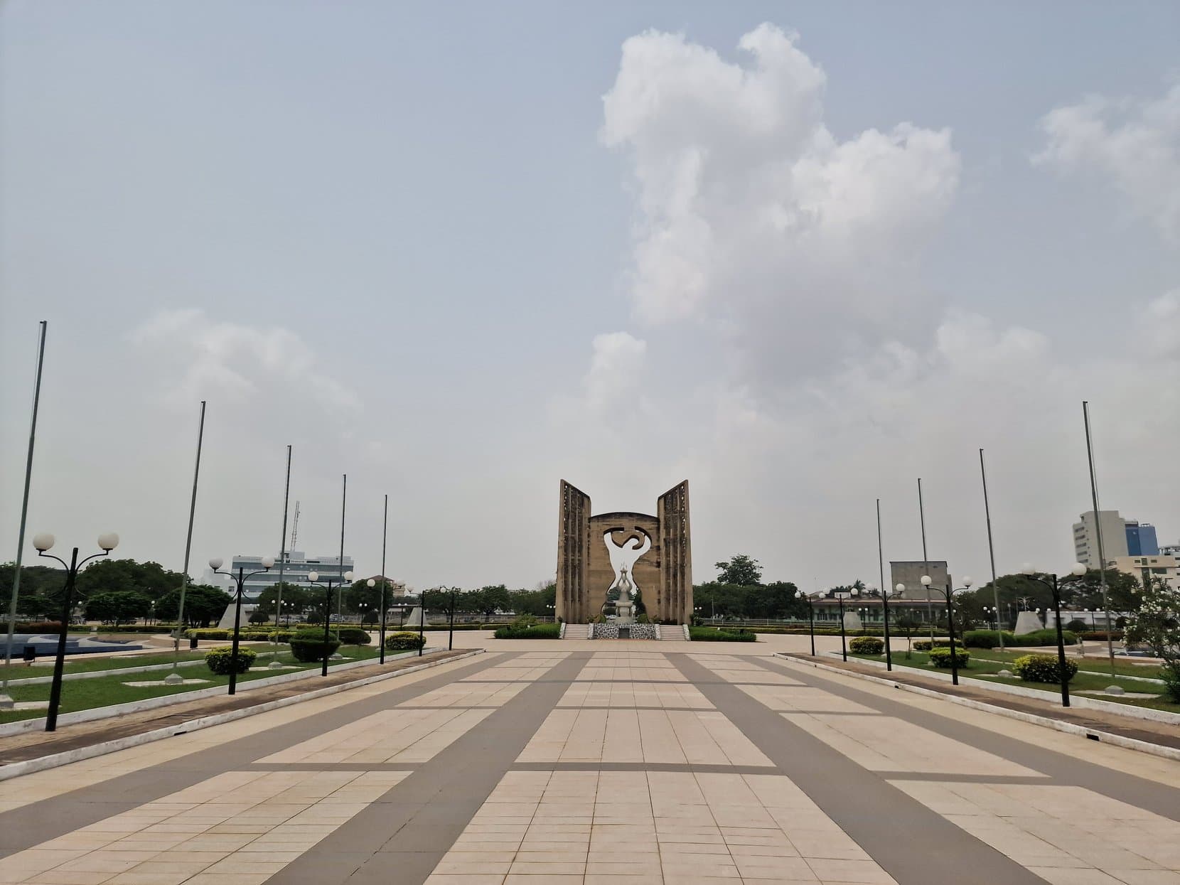 The wide empty paved plaza running toward the Independence Monument, Lomé, Togo