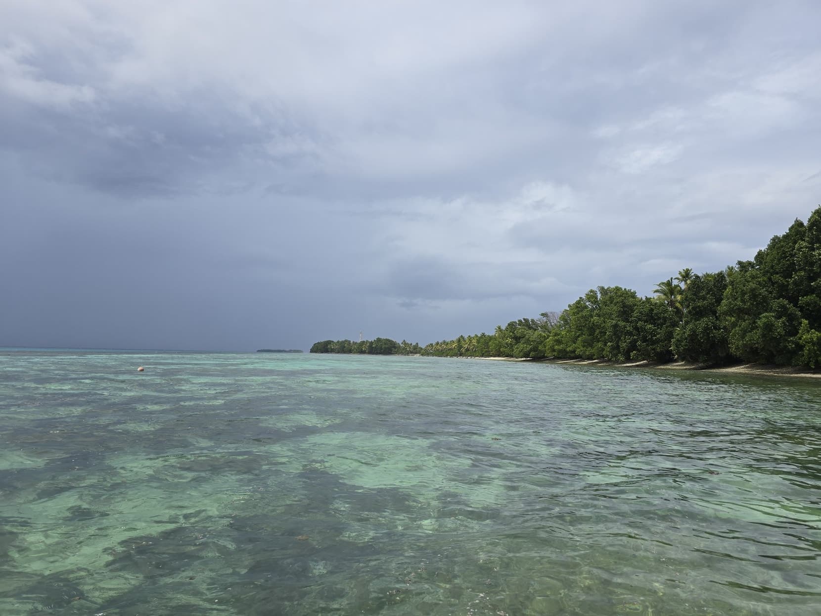 A lagoon islet under dramatic storm light