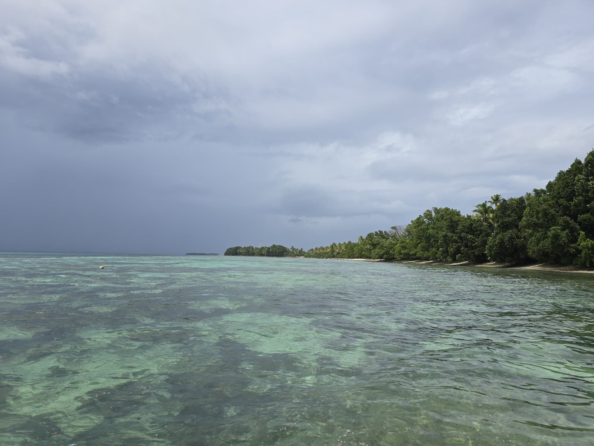 A lagoon islet under dramatic storm light
