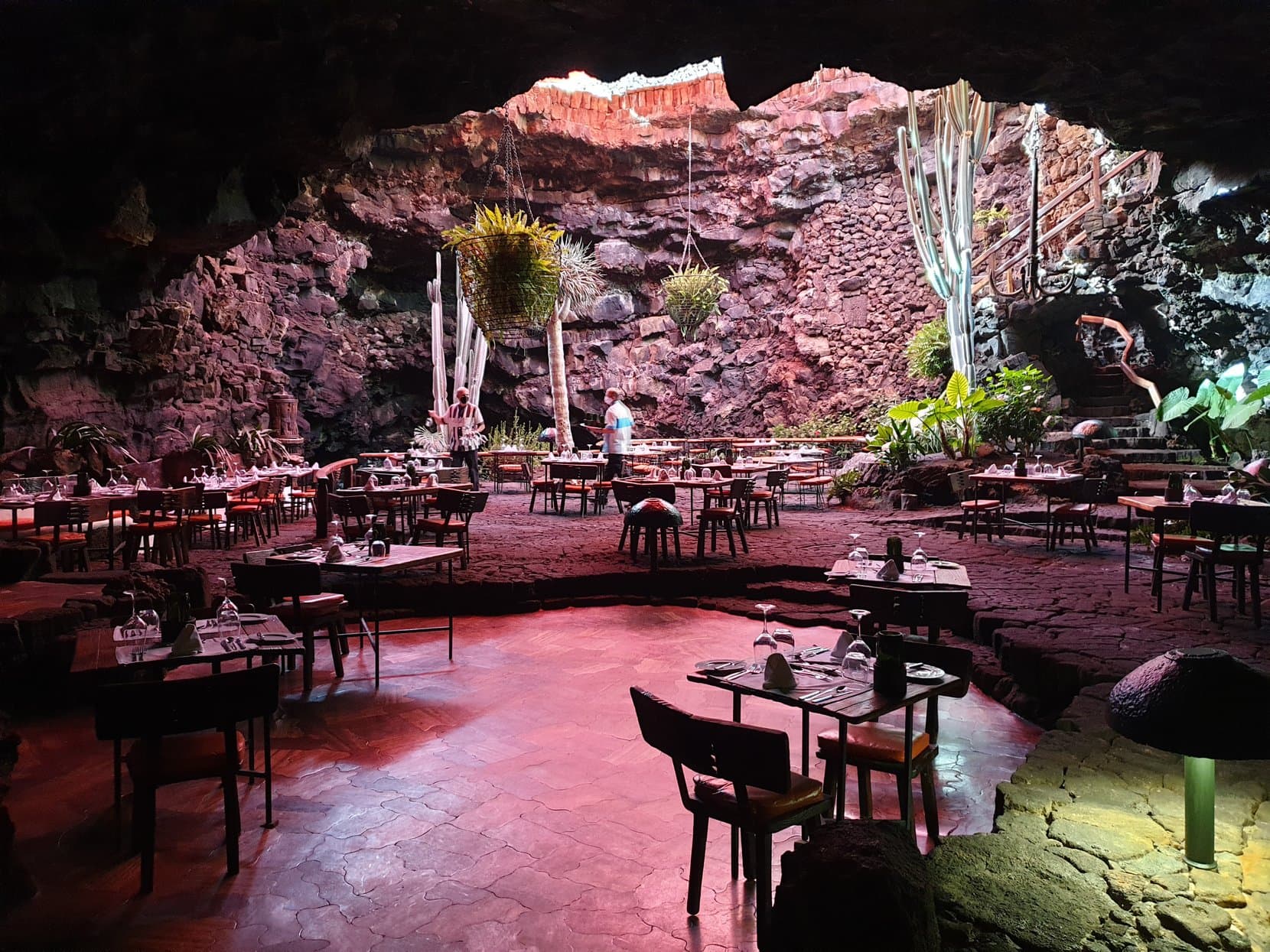 Tables set inside the red-lit lava cave of Jameos del Agua, Lanzarote