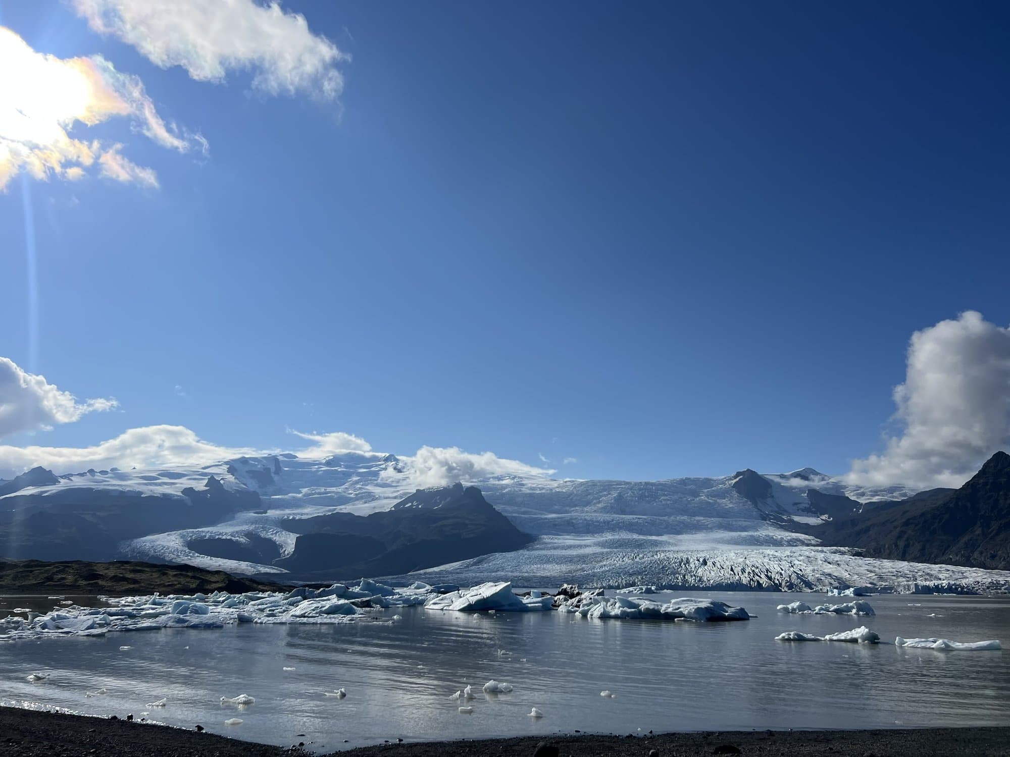 The Jökulsárlón lagoon packed with icebergs, the glacier tongue and mountains behind