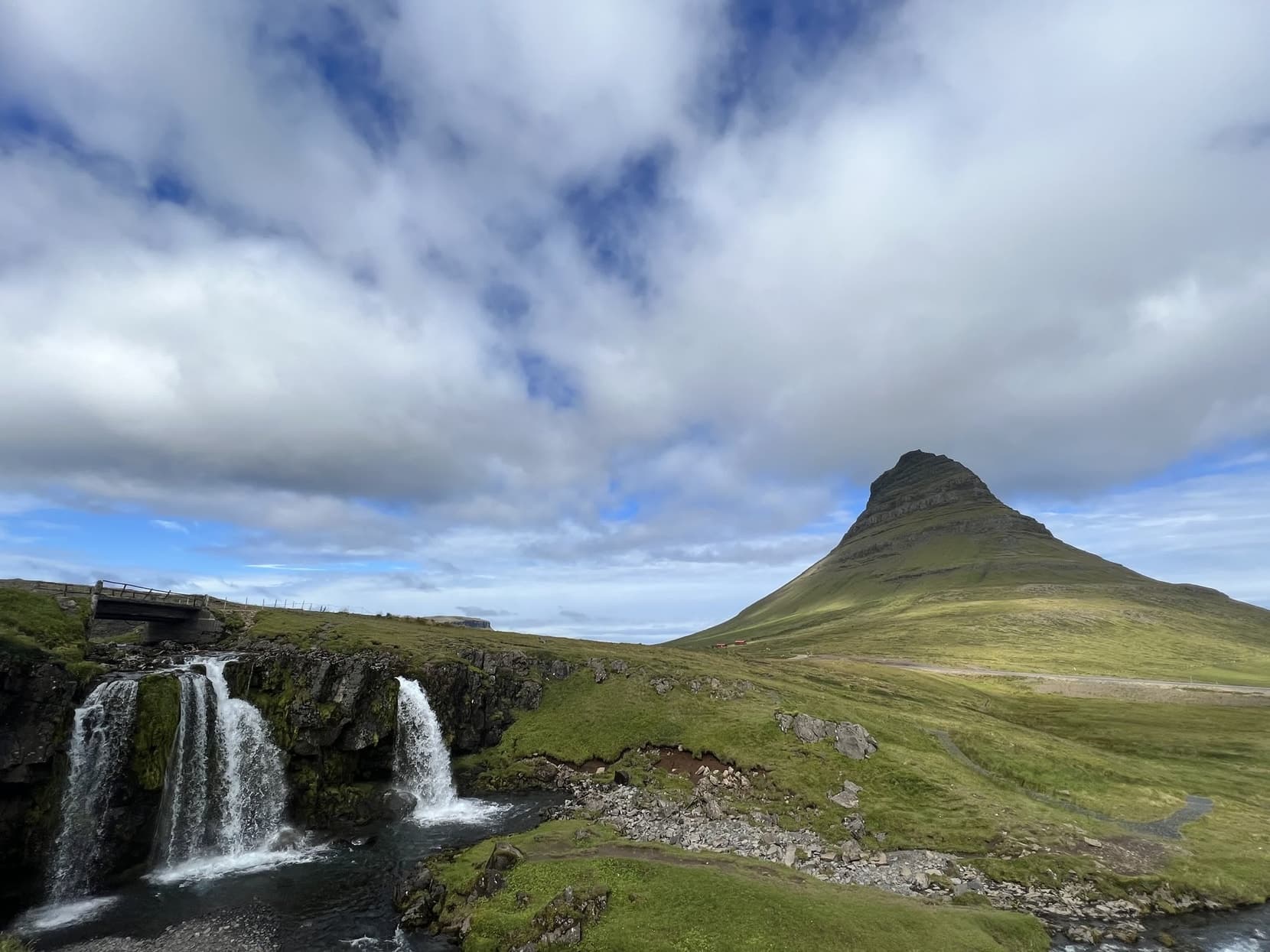 Kirkjufell rising behind the tiered Kirkjufellsfoss waterfalls, Snæfellsnes