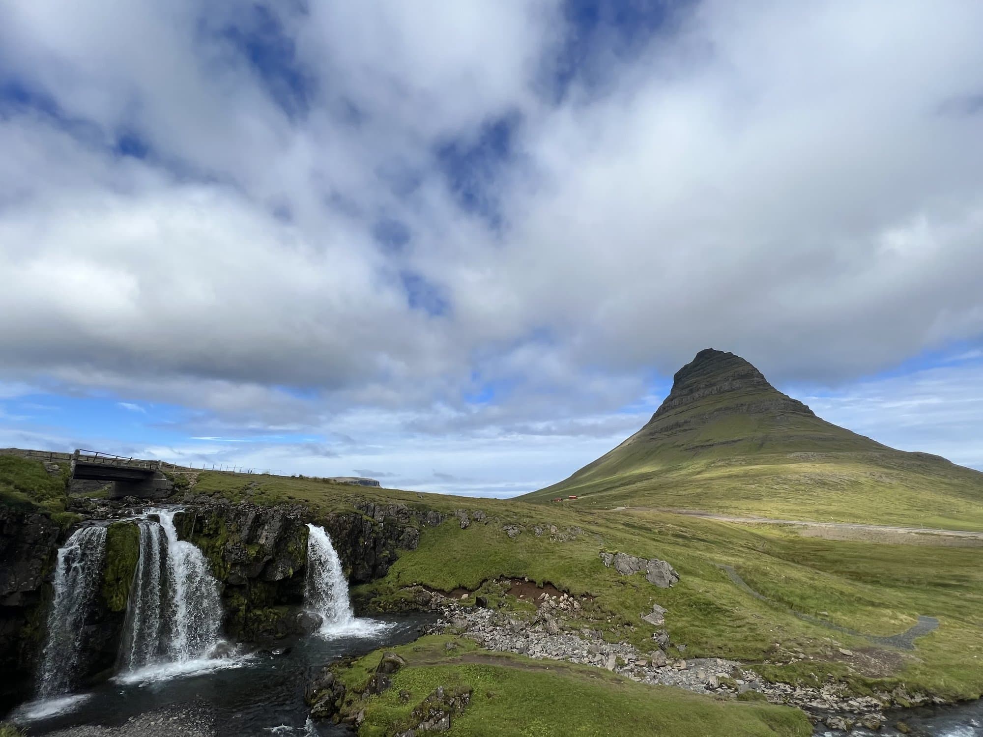 Kirkjufell rising behind the tiered Kirkjufellsfoss waterfalls, Snæfellsnes