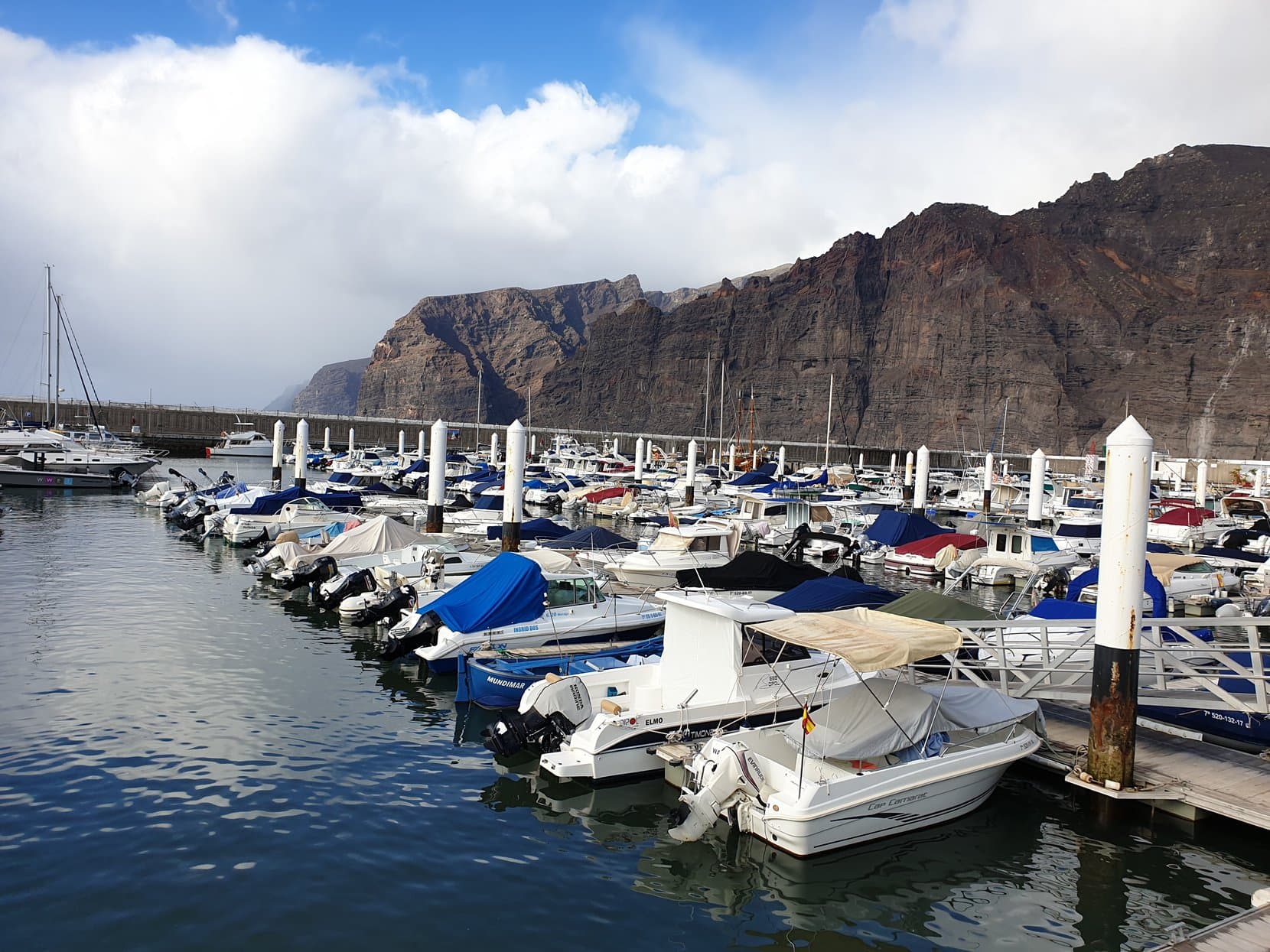 The marina of Los Gigantes sitting directly beneath its sheer cliff wall, Tenerife
