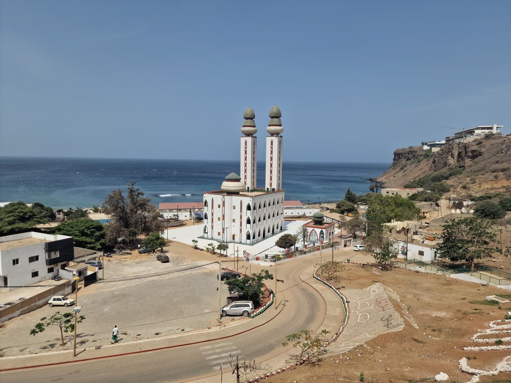 The white twin-minaret Mosquee de la Divinite at the edge of the Atlantic below the Mamelles