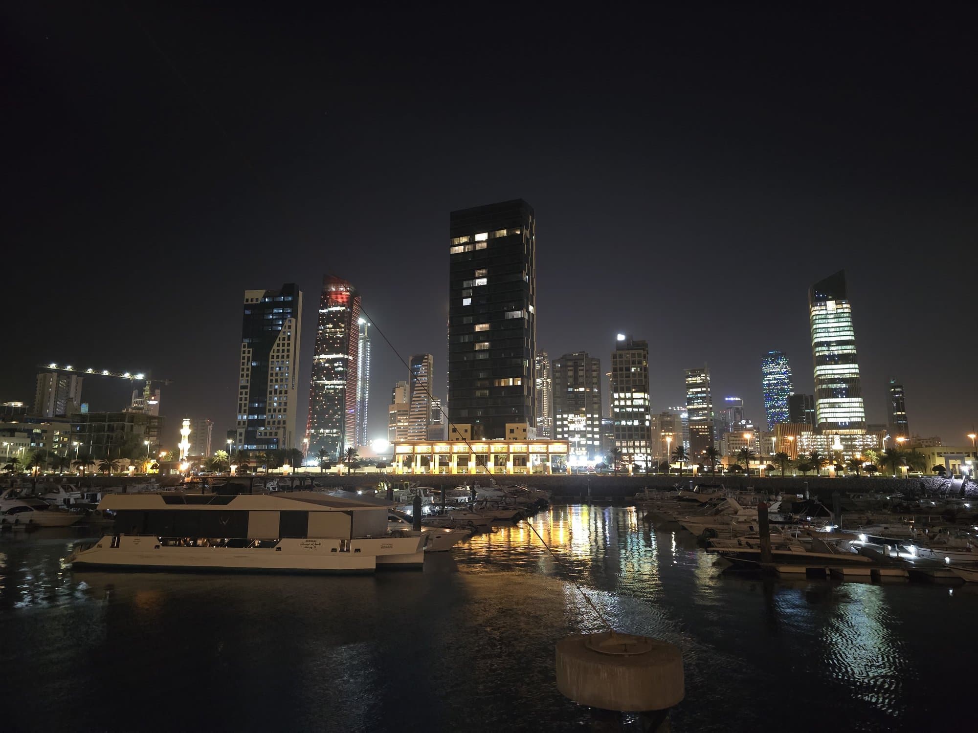 The night skyline from the marina, towers lit along the water