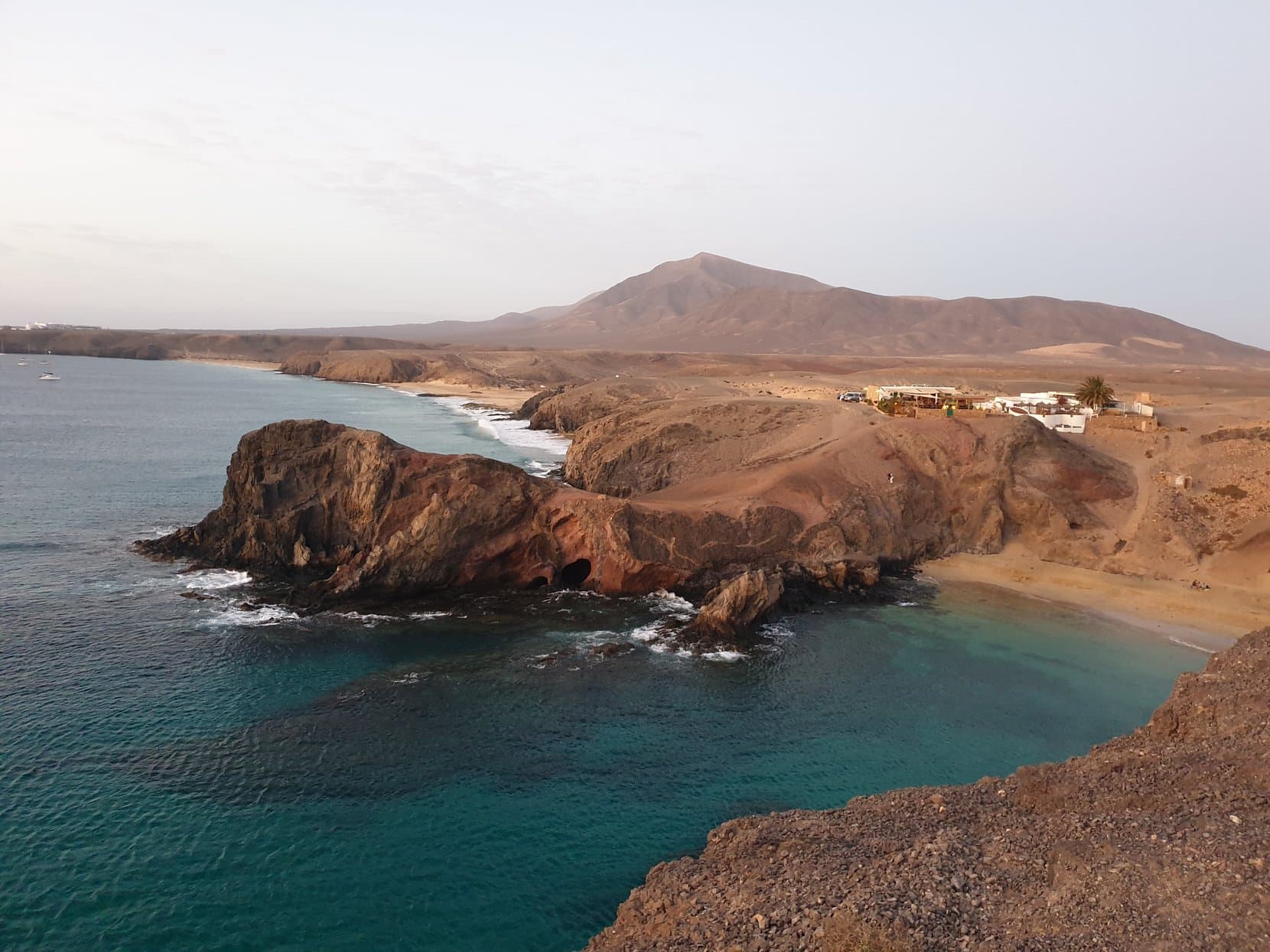 The turquoise coves and red headlands of Punta del Papagayo at golden hour, Lanzarote