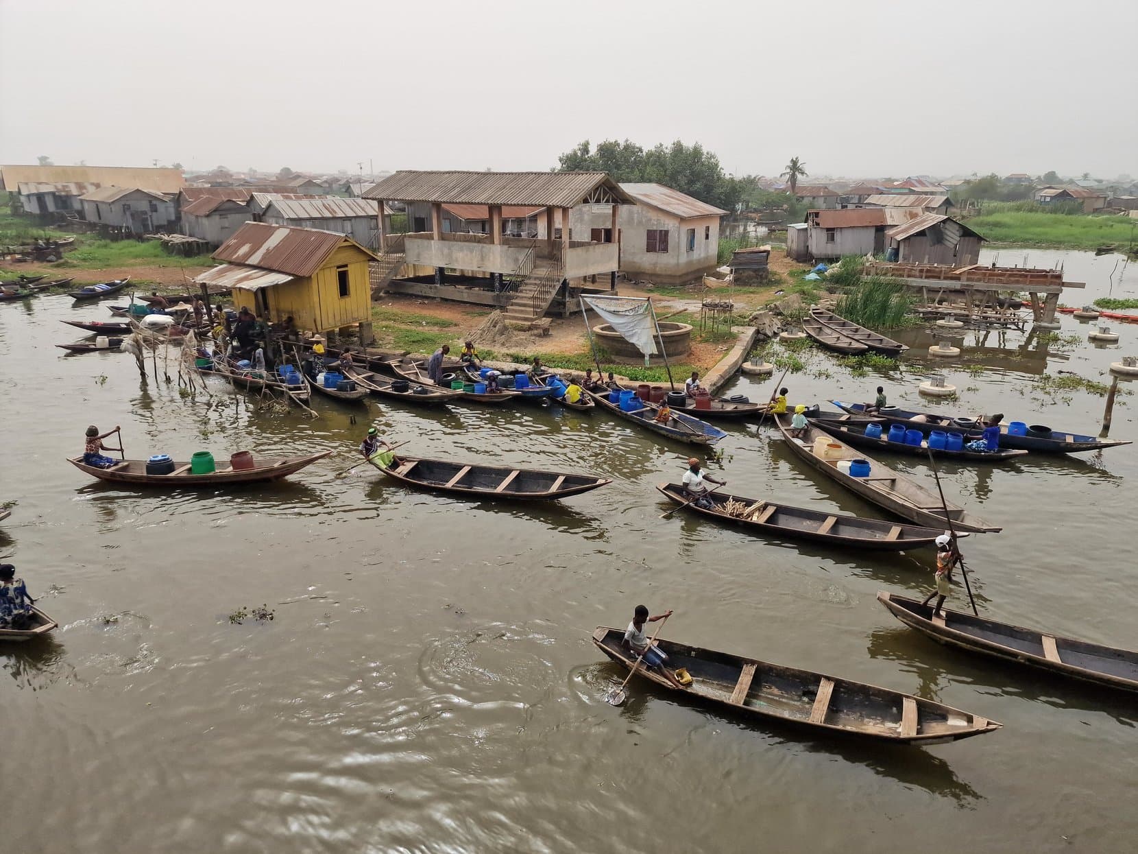Dozens of wooden pirogues moored below the stilt houses on the waterfront at Ganvié, Benin