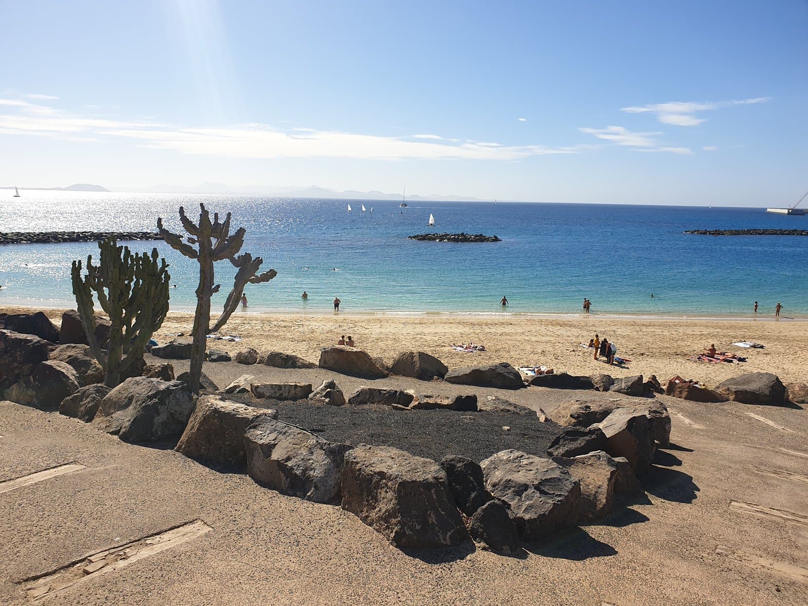 Cactus above the beach and turquoise water at Playa Blanca, Lanzarote