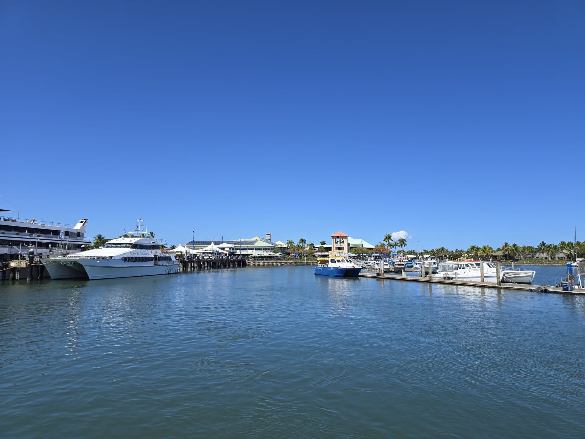 Yachts and catamarans moored at the Port Denarau marina under a blue sky