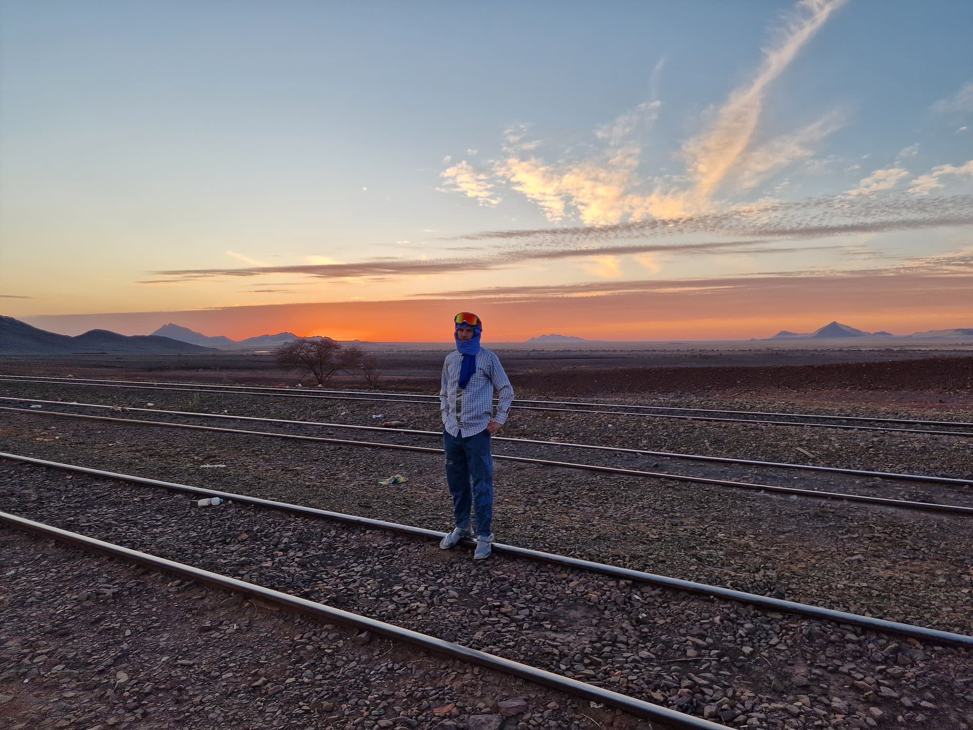 A lone figure on the rails at dusk waiting for the ore train