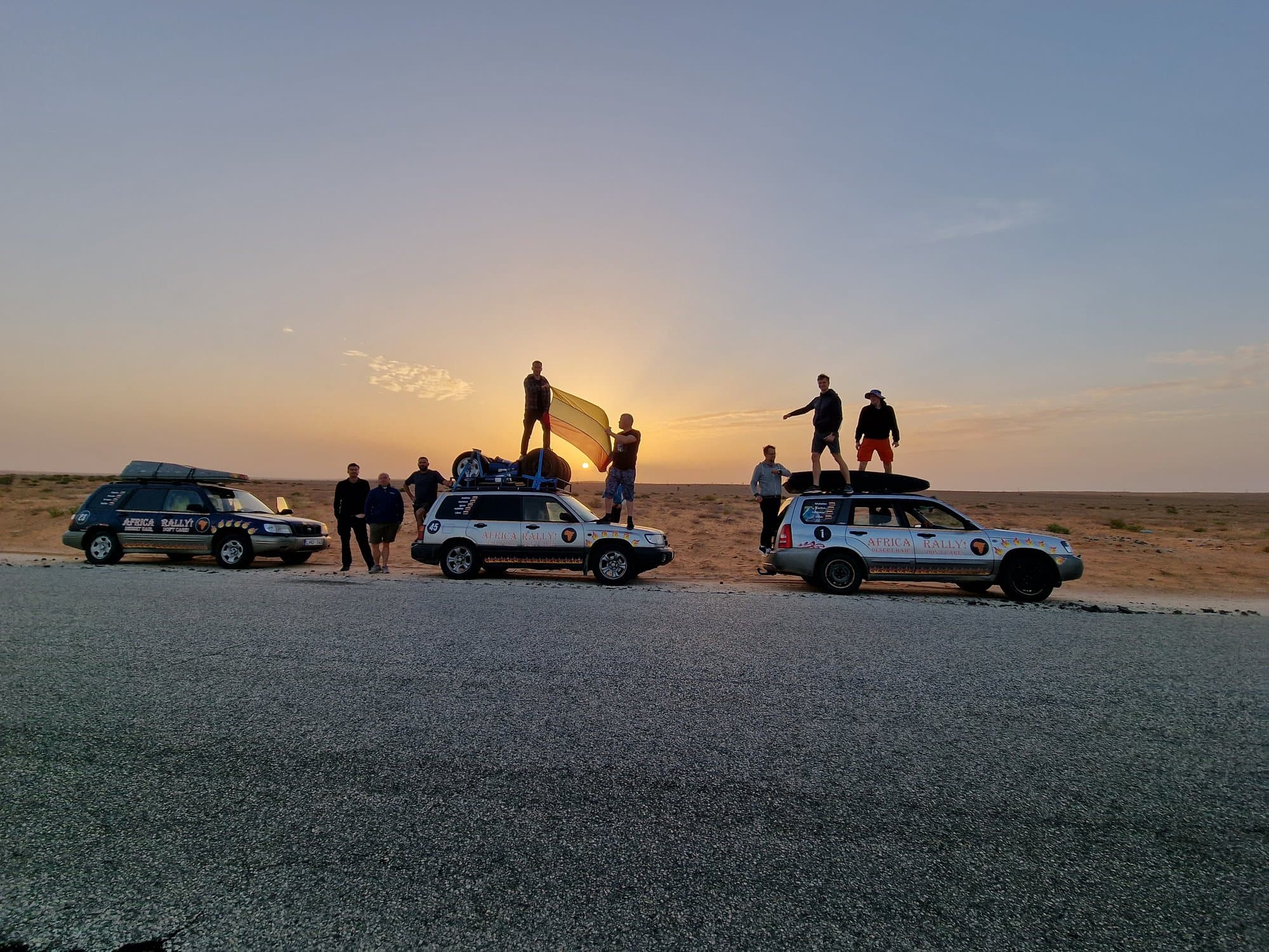 Cars parked on the empty desert highway at dawn