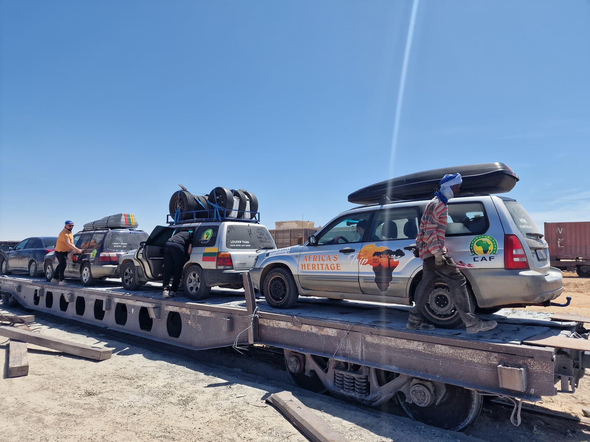 Rally cars loaded onto flatcars of the iron-ore railway