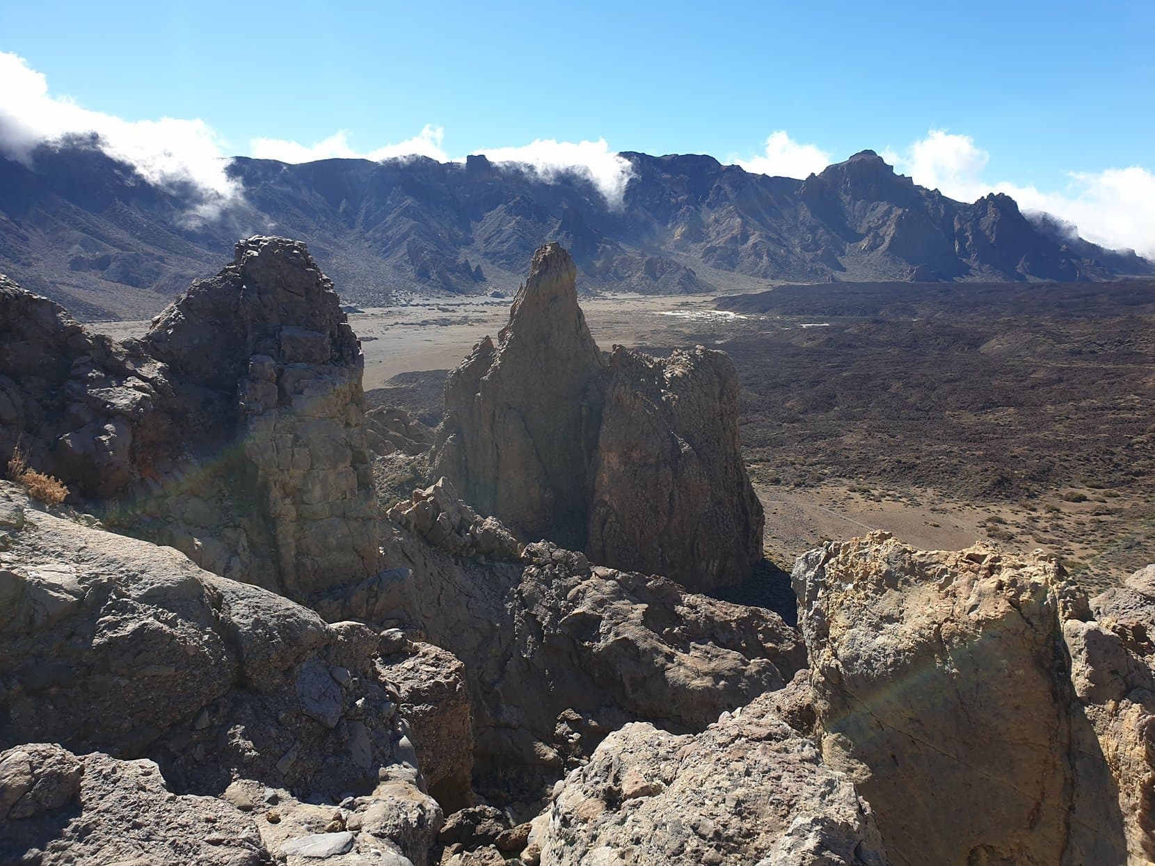 The Roques de García spires over the Llano de Ucanca, with cloud spilling over the caldera rim, Tenerife
