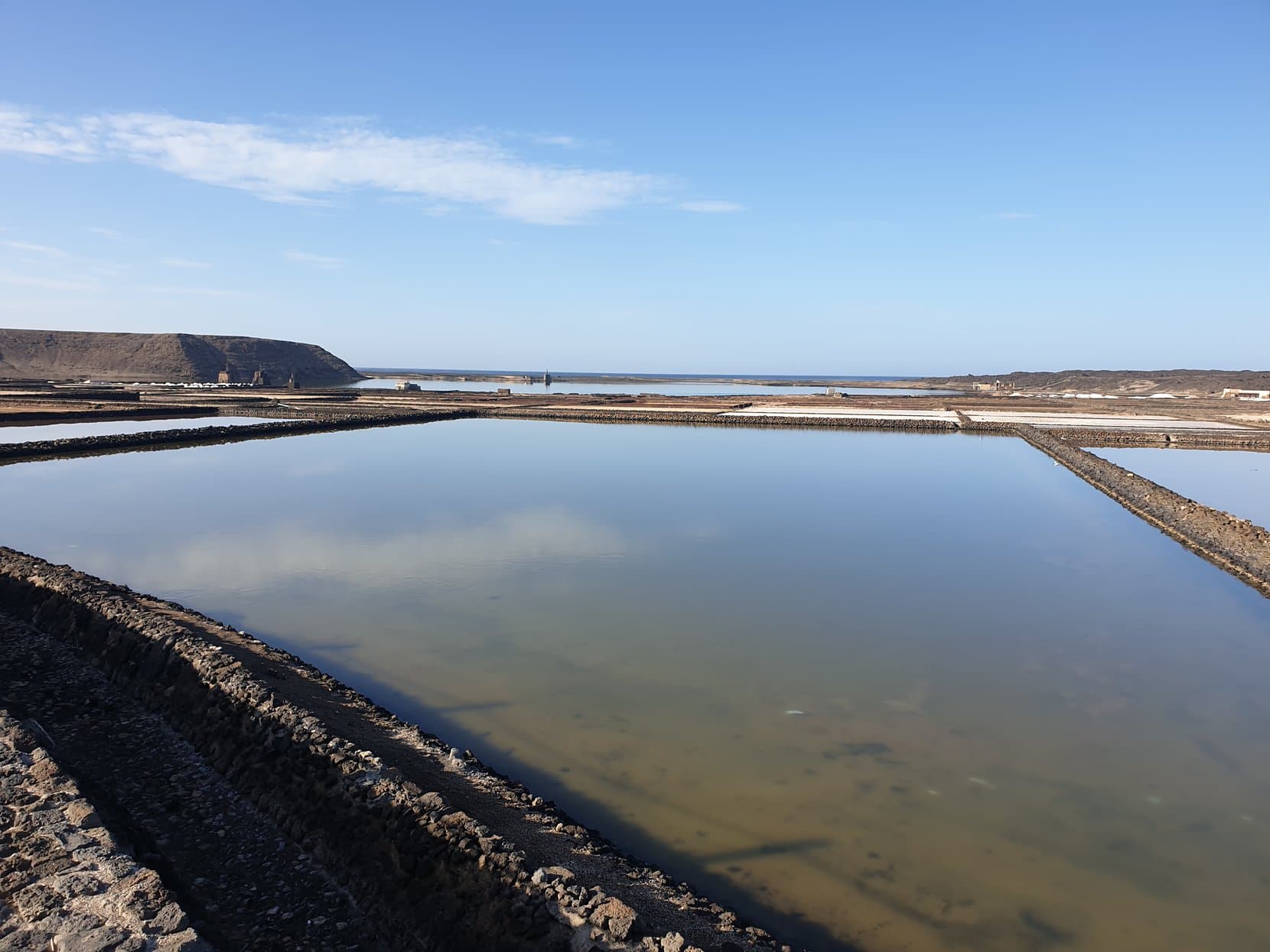 The salt pans of Janubio mirroring the sky on Lanzarote's west coast