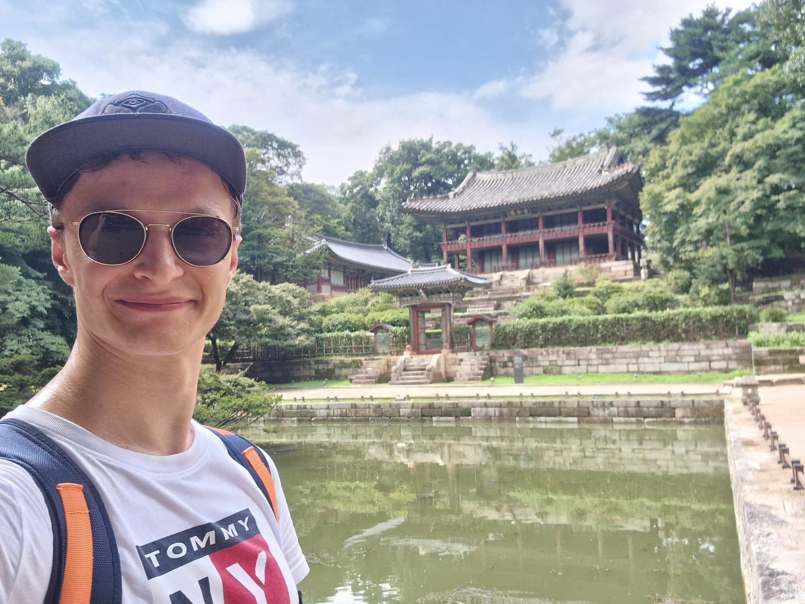Buyongji pond and its pavilions in the Secret Garden of Changdeokgung palace, a visitor at the rail, Seoul