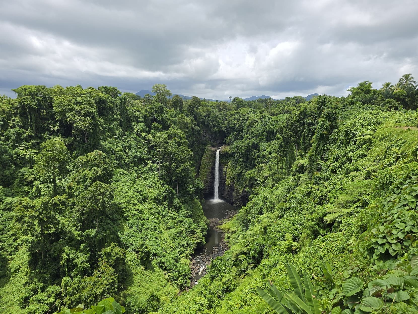 Sopo'aga Falls dropping into a green jungle gorge on Upolu