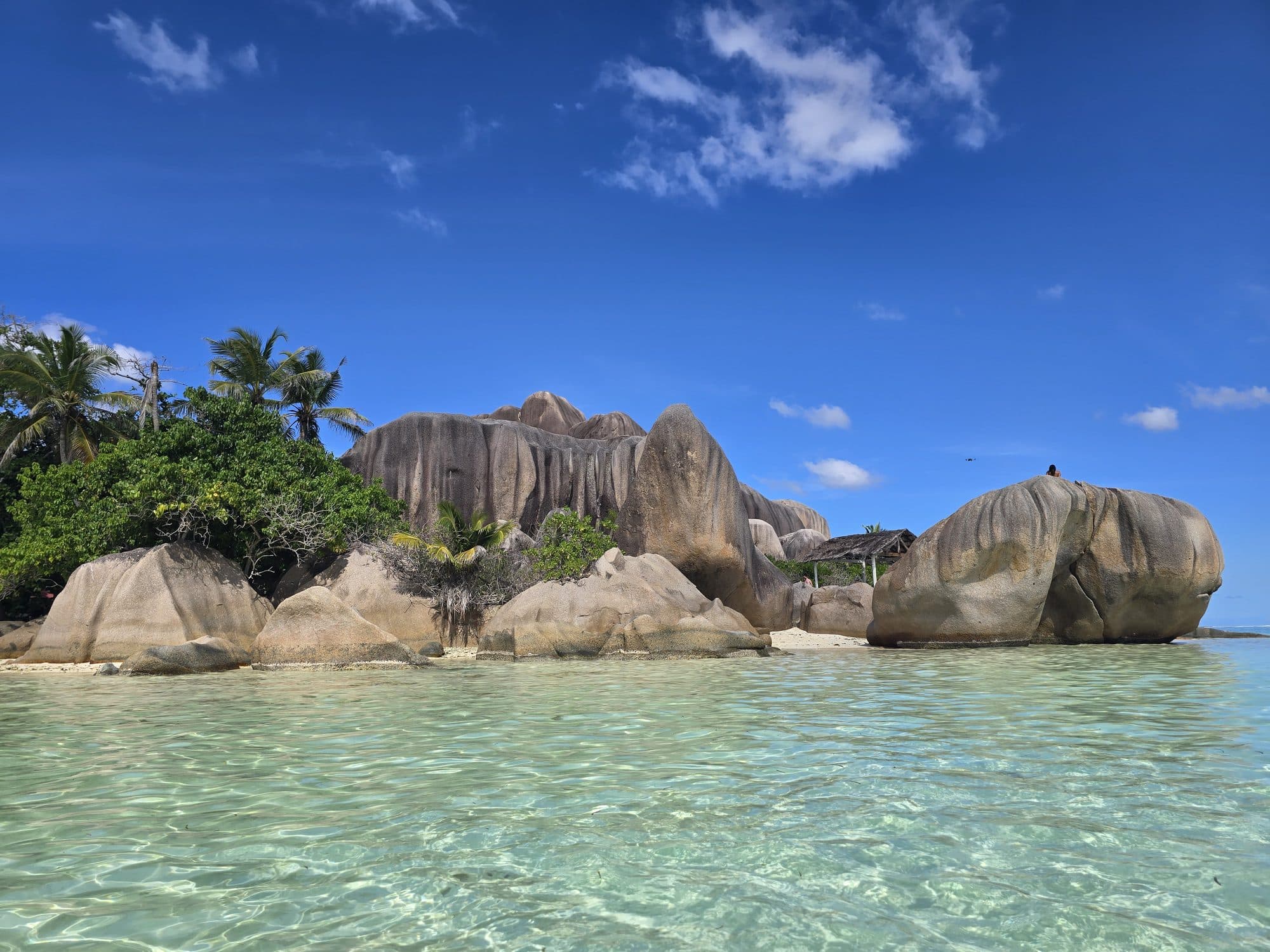 The granite boulders of Anse Source d'Argent seen from the water, La Digue, Seychelles