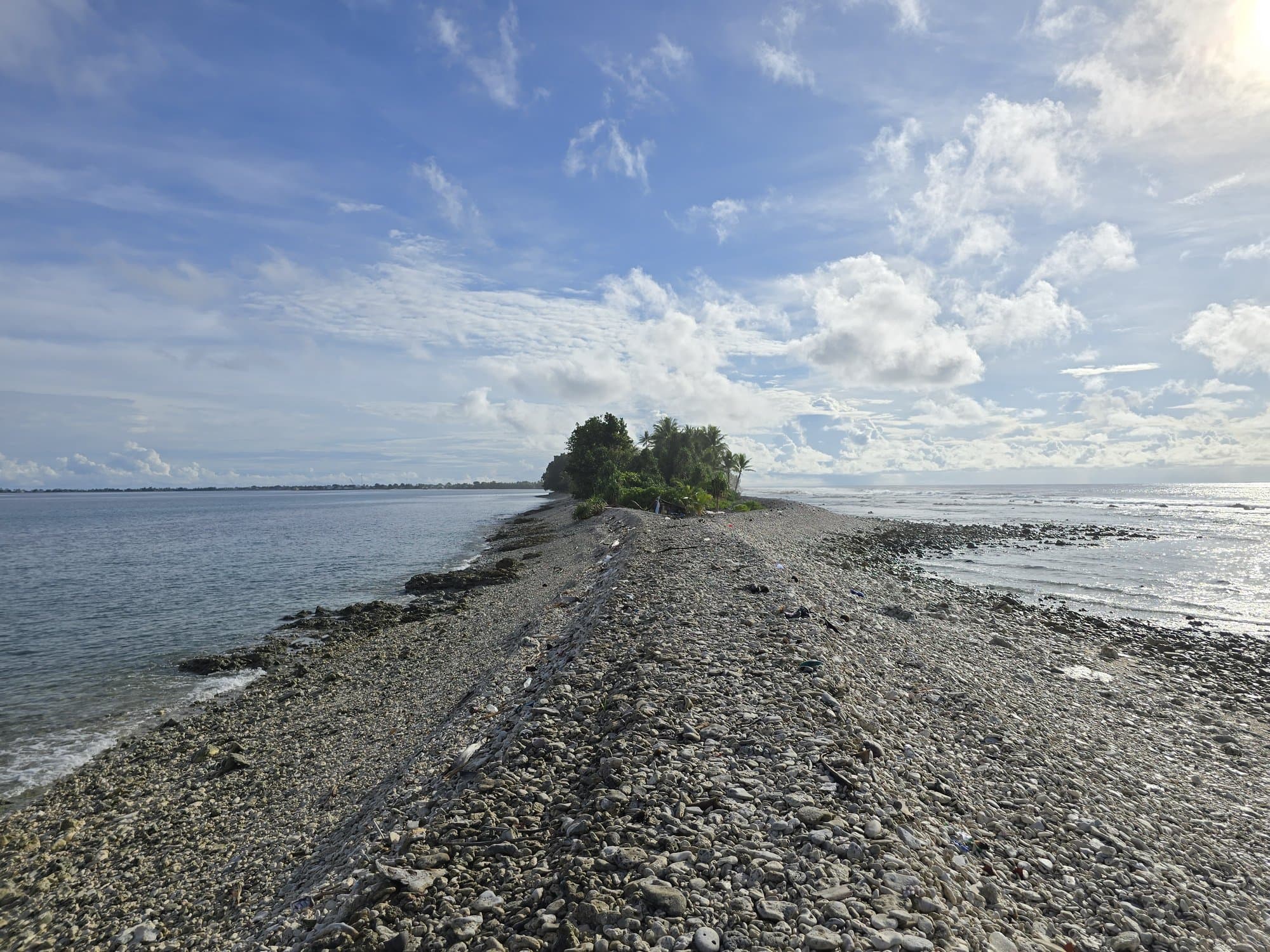 The rubble spit at low tide running out toward the islet off Fongafale's southern tip