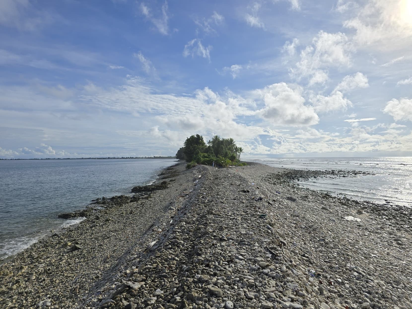 The rubble spit at low tide running out toward the islet off Fongafale's southern tip