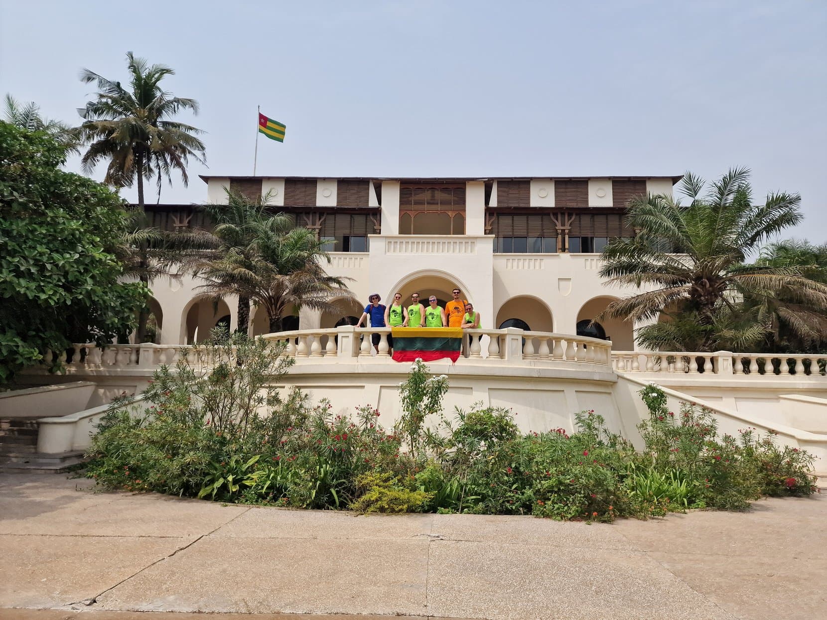 The rally crew on the balcony of the Palais de Lomé under a Togolese flag, Togo