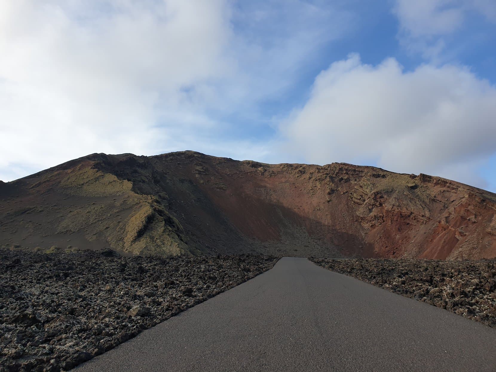 The park road running straight into the red and black volcano cones of Timanfaya, Lanzarote