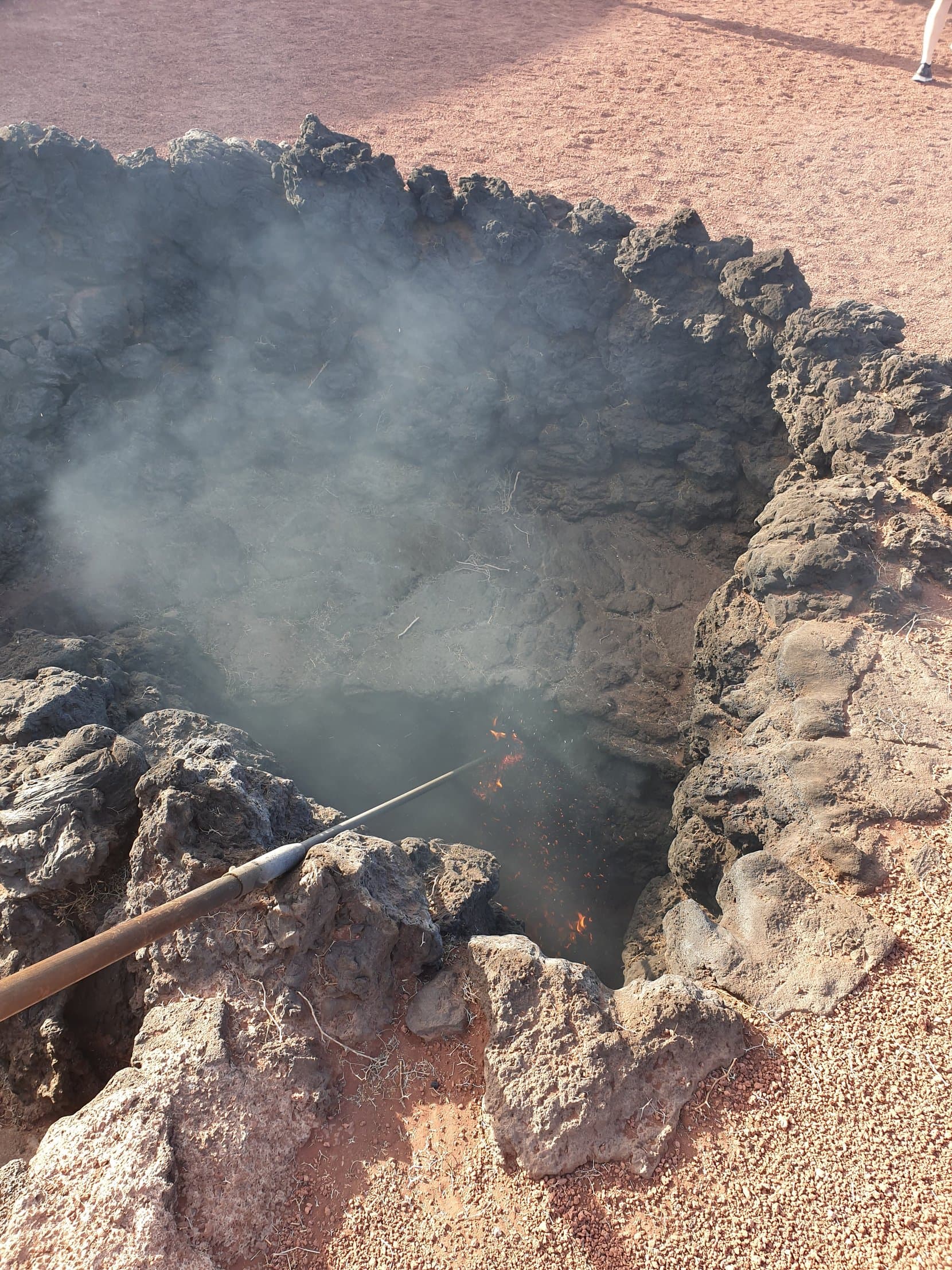 Steam erupting from a vent in the rocks during the geyser demonstration at Timanfaya, Lanzarote